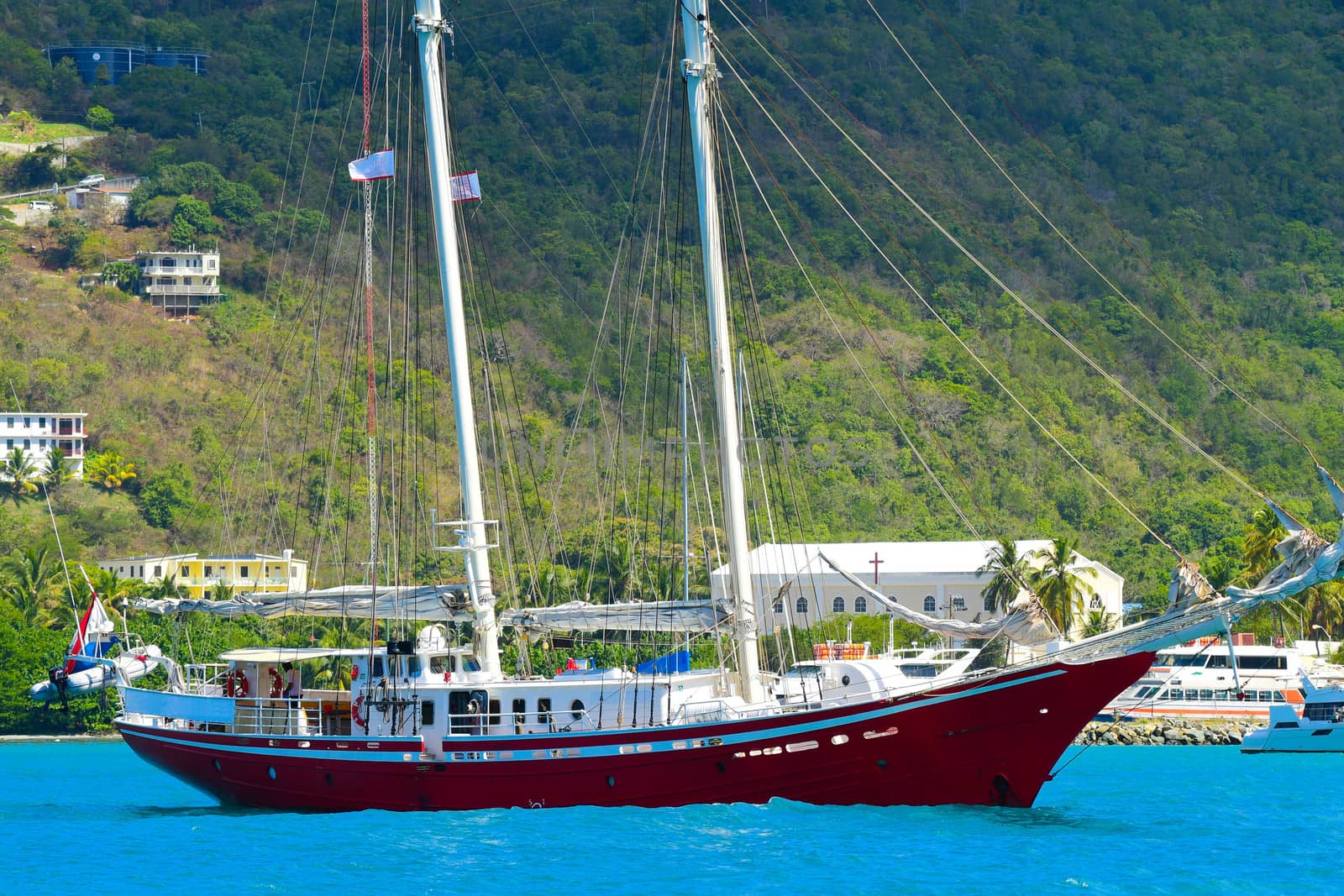 Large red sailing schooner at anchor in British Virgin Islands harbor.