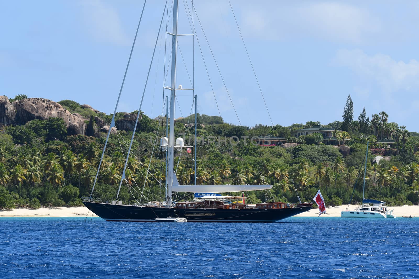 Large Sloop at anchor  with tender alongside in British Virgin Islands