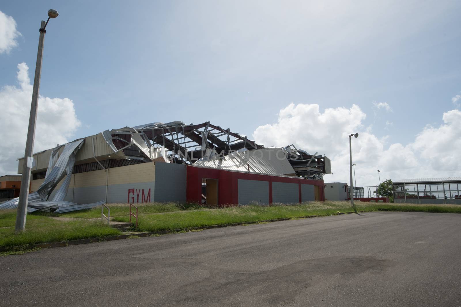 Aluminum roof blown off high school gymnasium by Hurricane Maria