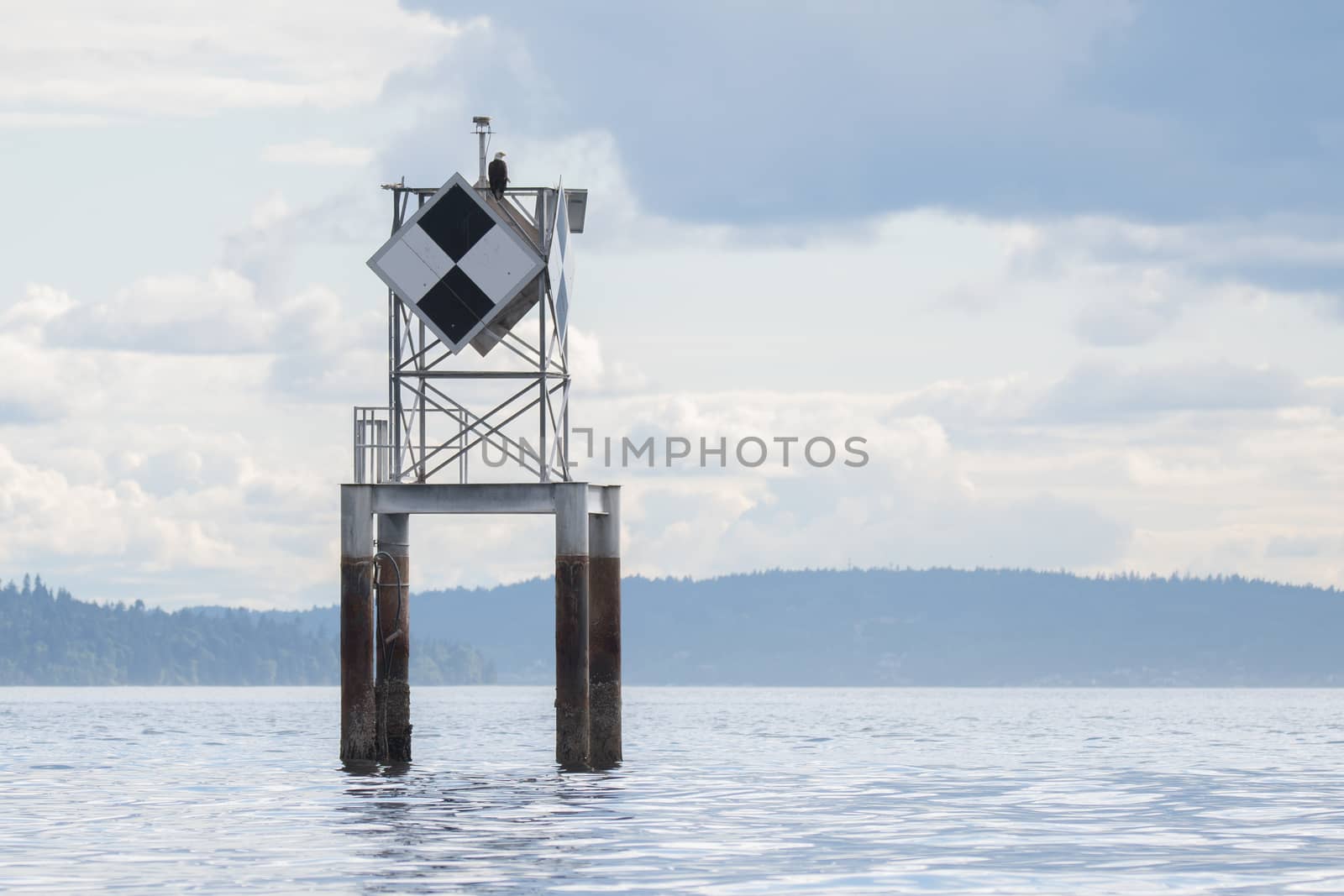 Calm, cloudy day.  Daymark positioned in West Seattle, WA.  The bald eagle was a bonus