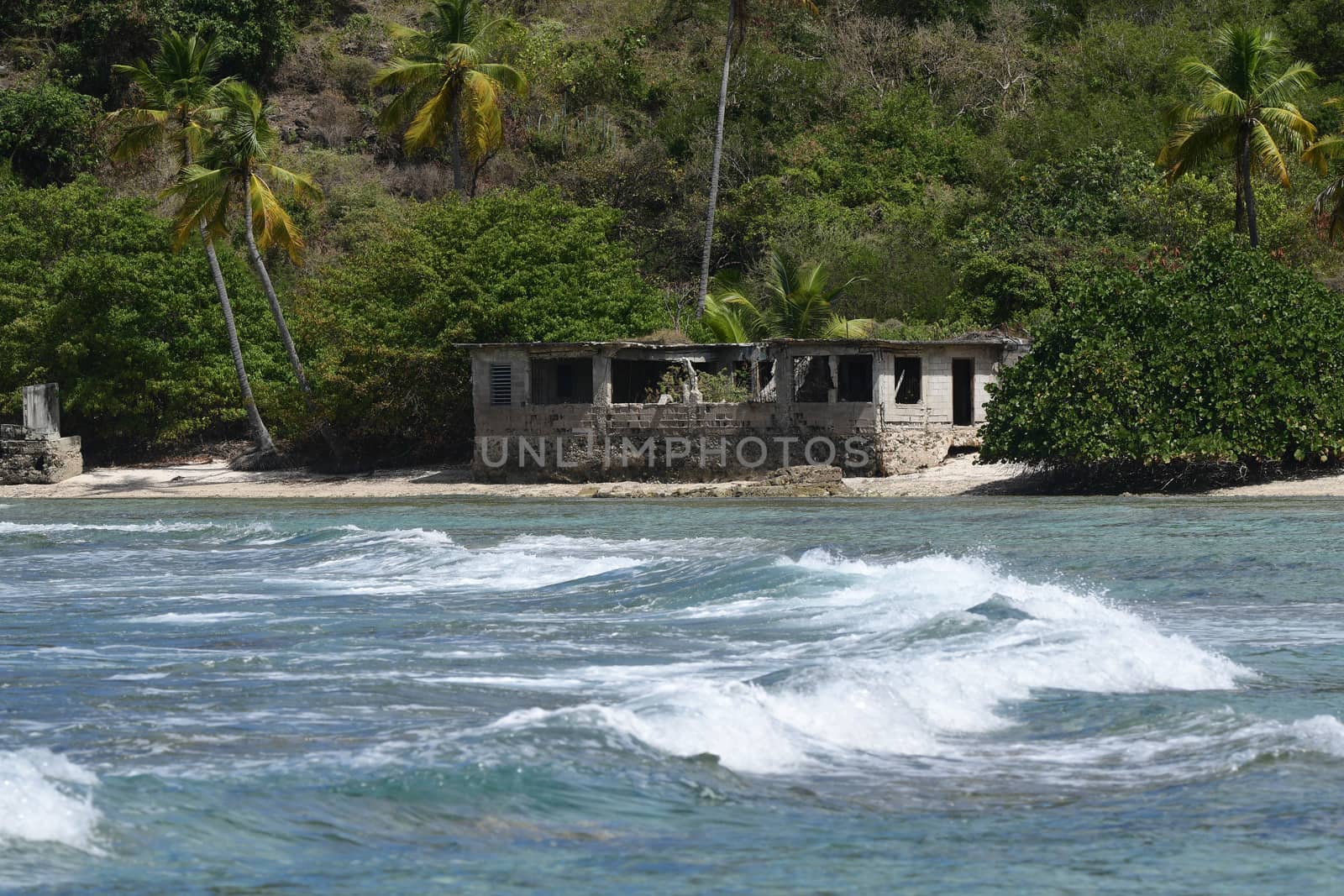 House on British Virgin Islands beach viewed from across lagoon