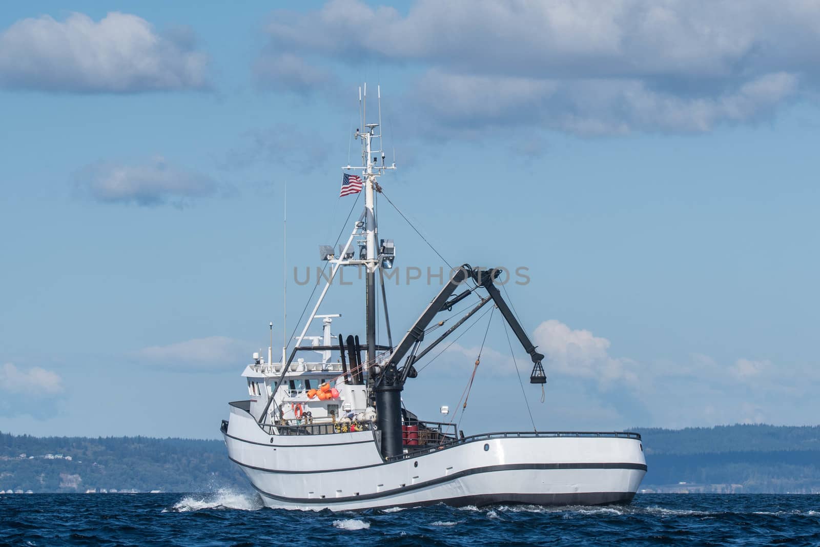 Crab fishing vessel Paragon underway under lightly cloudy skies and calm seas in Puget Sound.