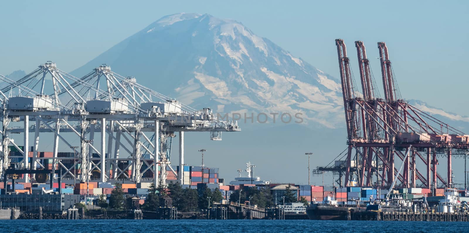 Container Cranes loom over Duwamish Waterway with Mount Rainier in the background.