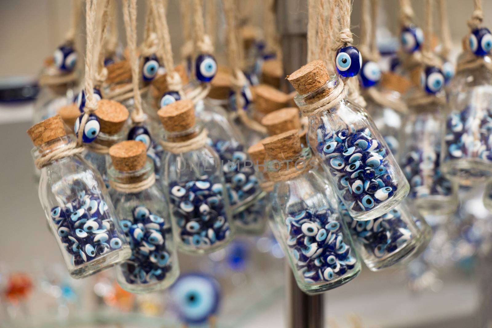 Little glass bottle filled with blue evil eye beads  by berkay