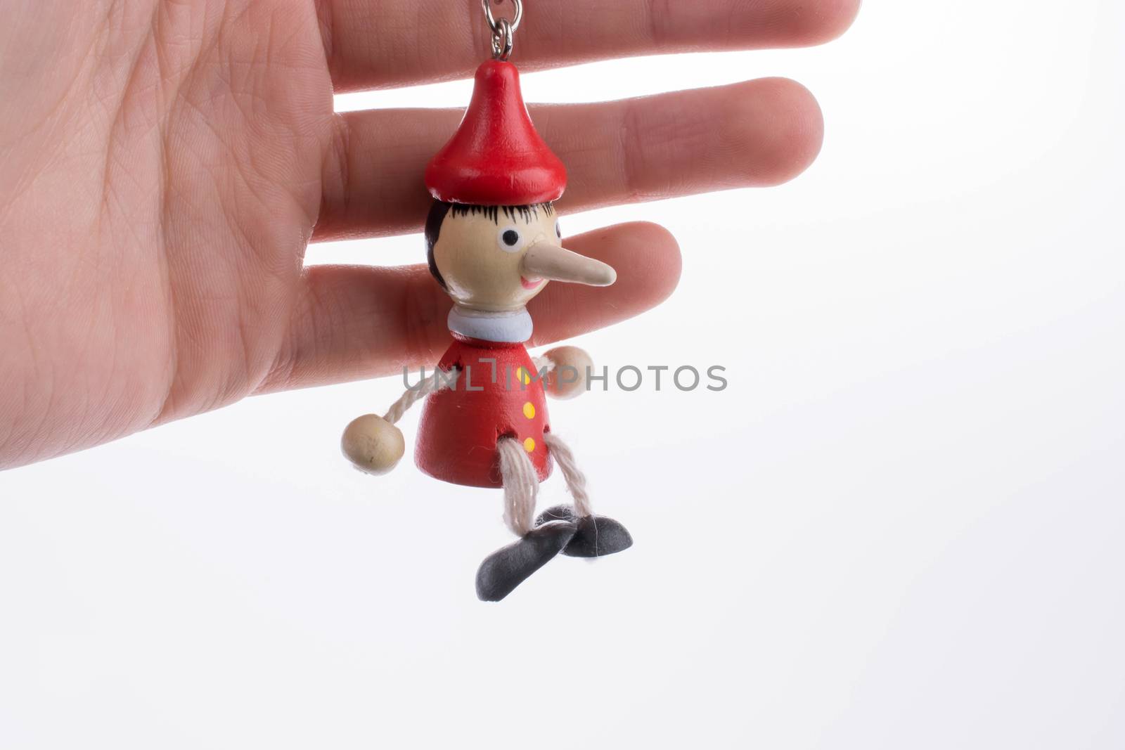 Wooden pinocchio doll with his long nose by berkay