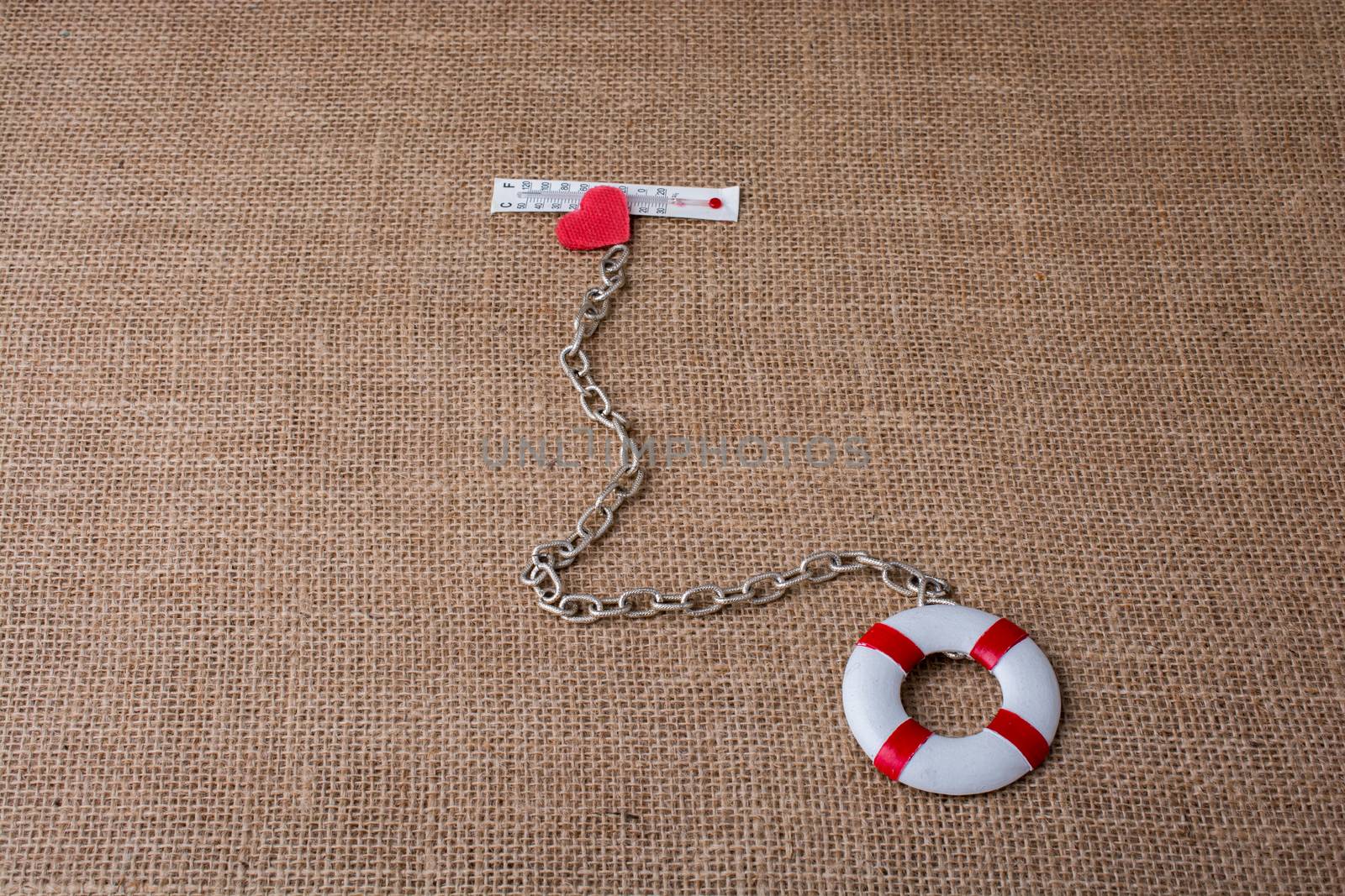 Heart attached to a life preserver and athermometer