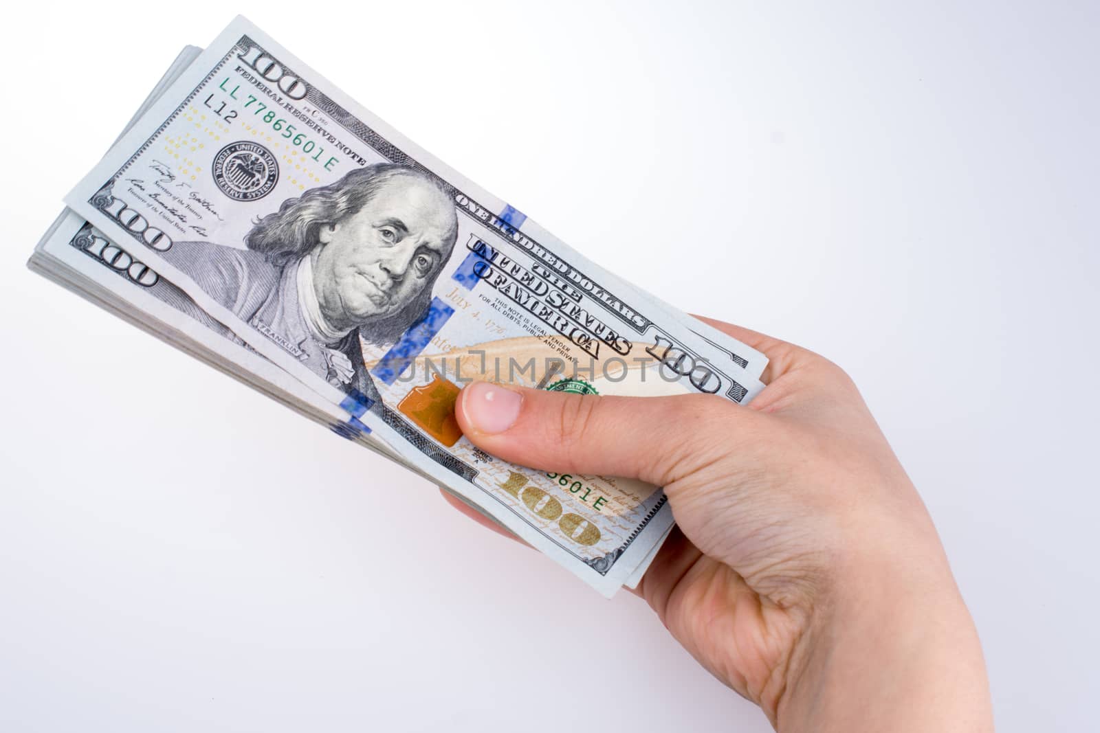 Human hand holding American dollar bill as money isolated on white