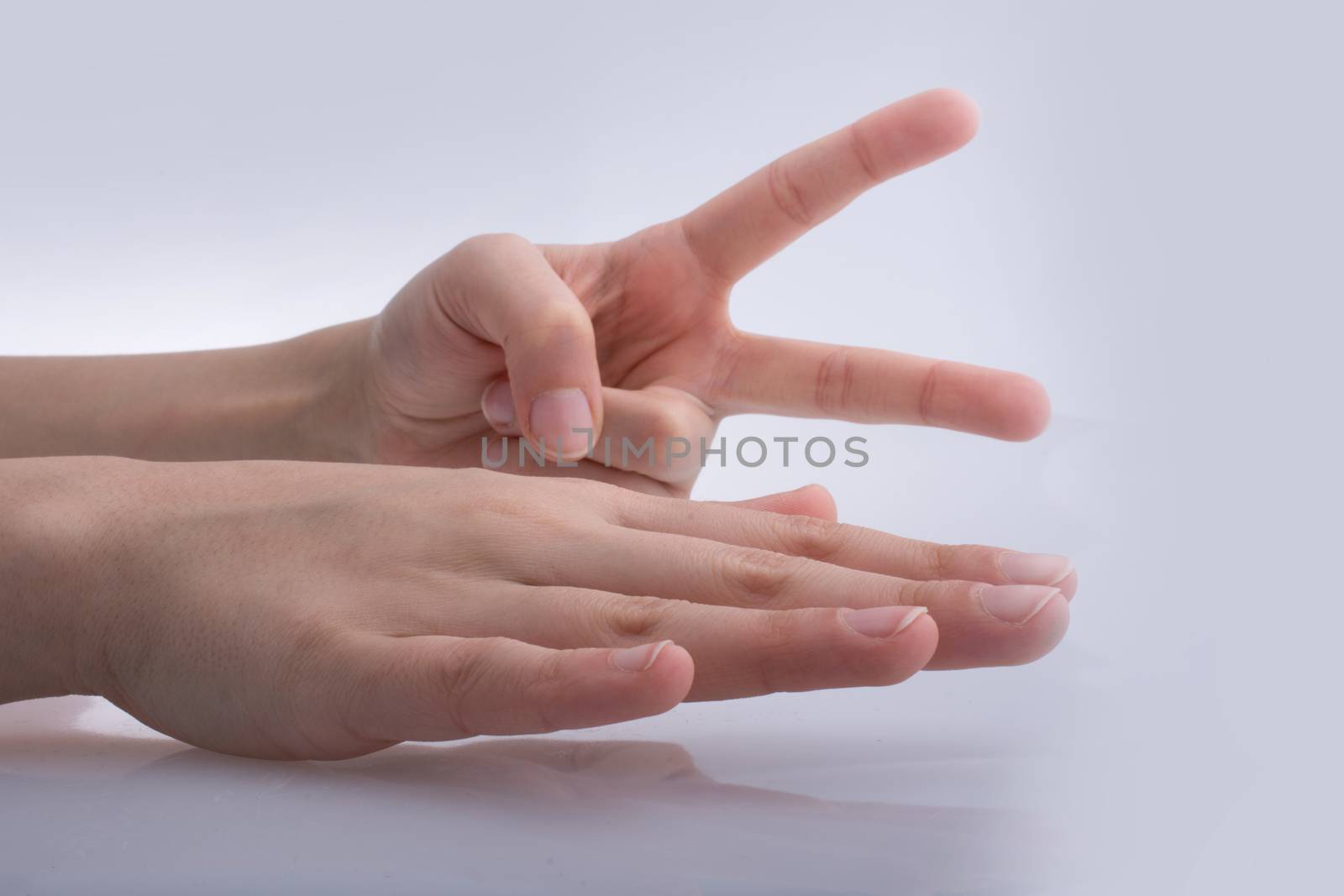 Hands showing the symbols rock paper scissors