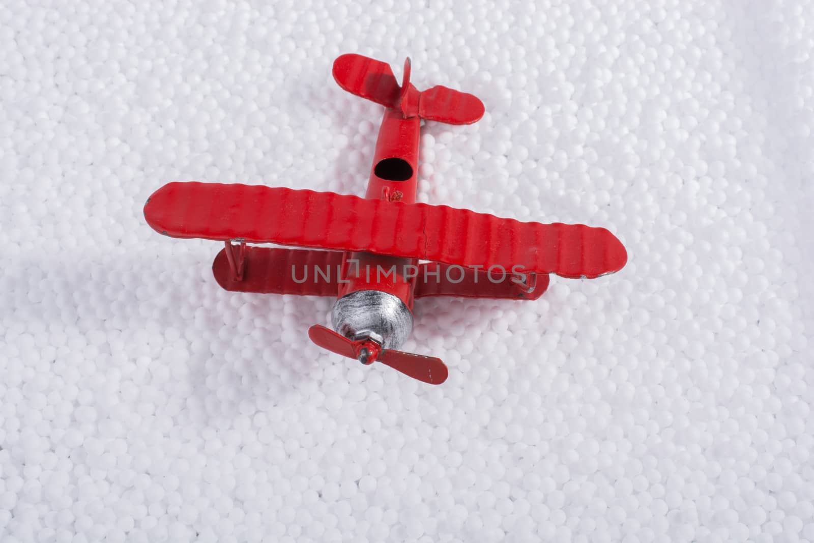 Toy airplane on little  white polystyrene foam balls