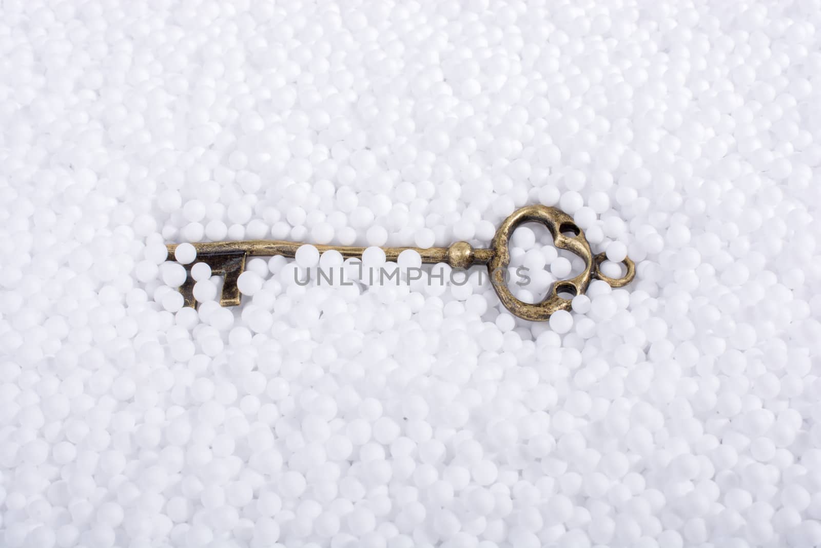 Retro key on white polystyrene foam balls  by berkay