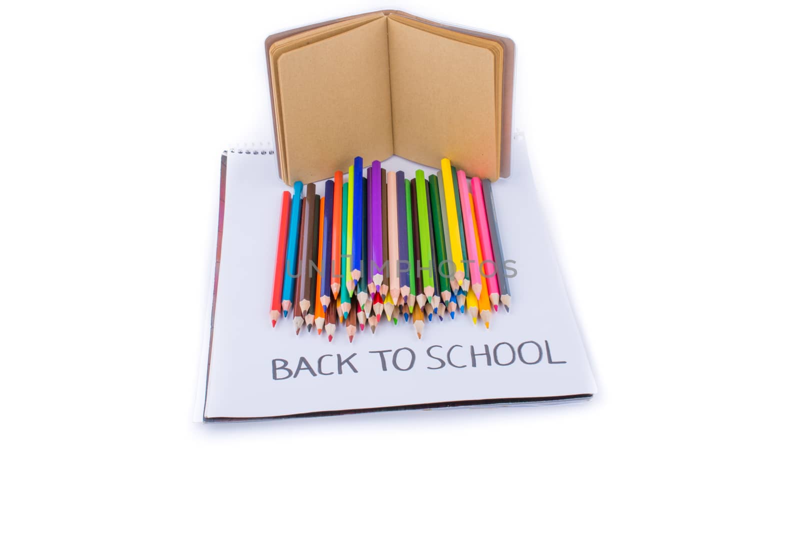 Color pencils, back to school title and a notebook