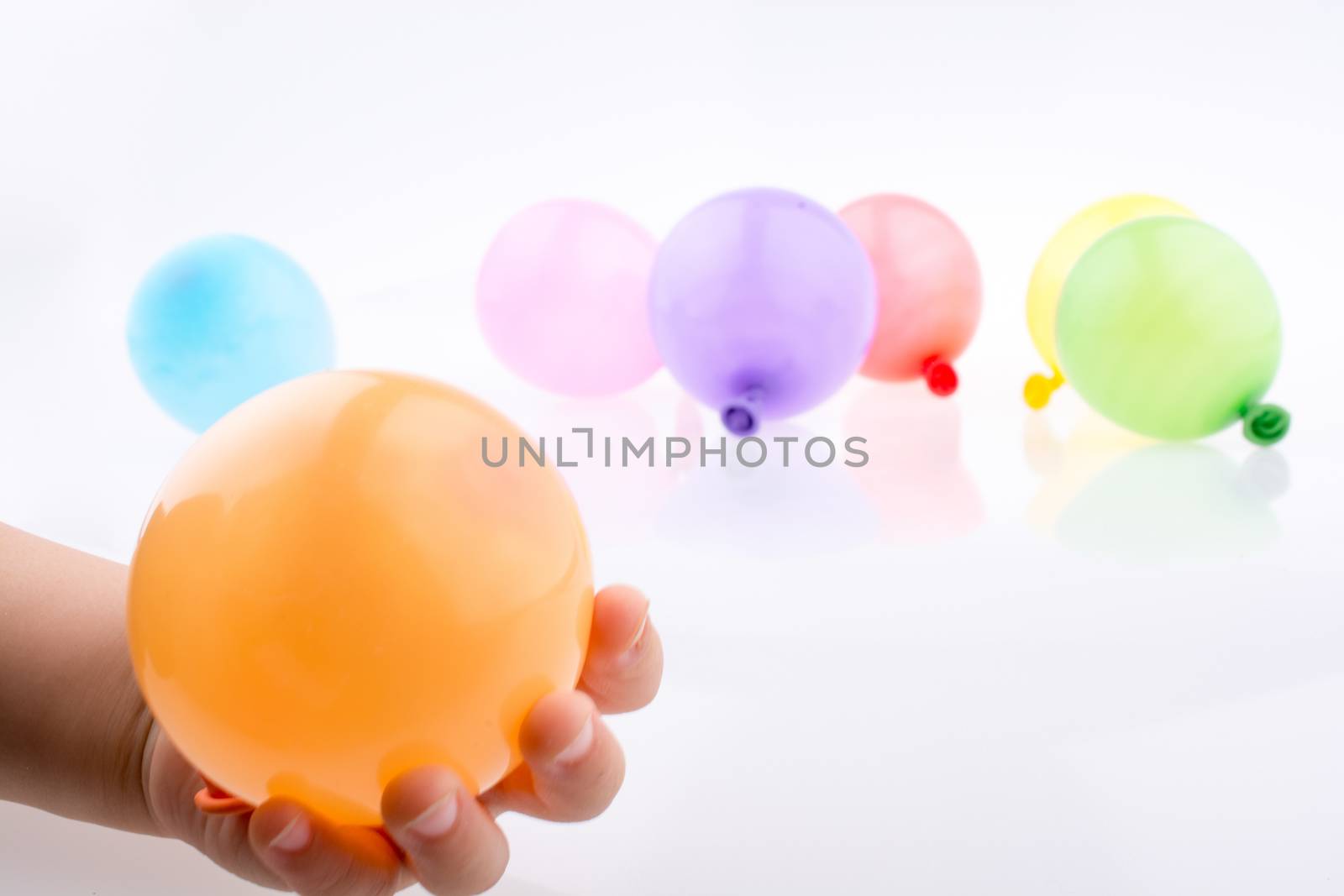 Hand holding a Colorful small balloon in hand  by berkay