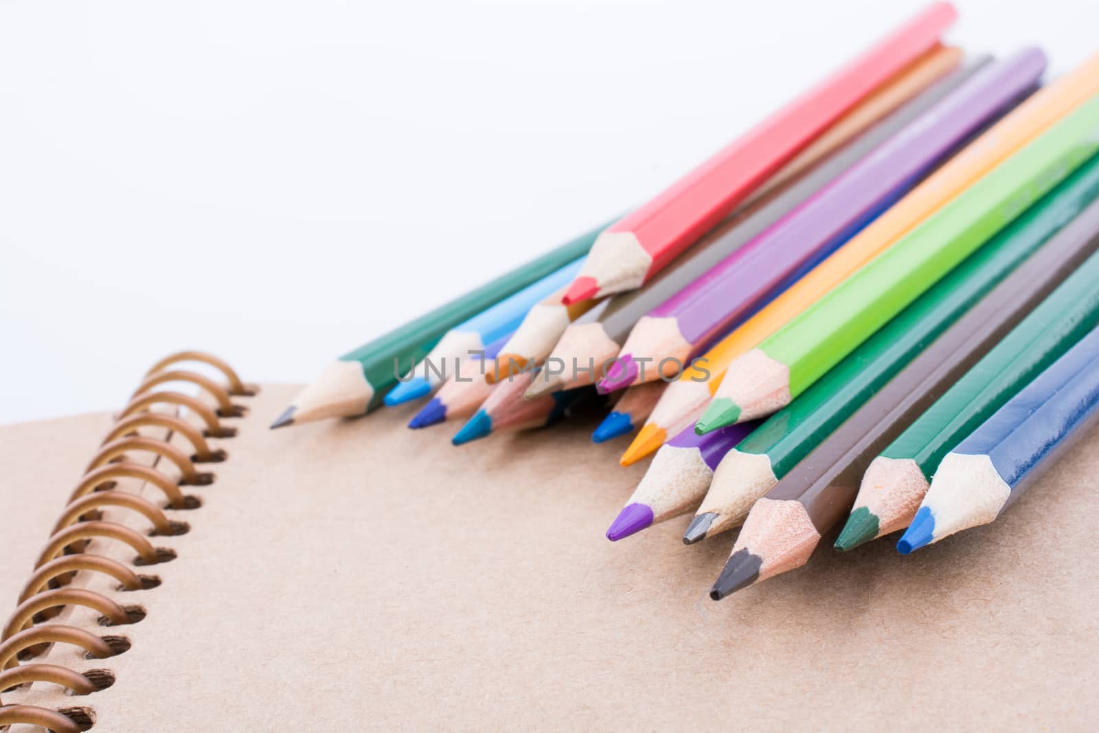 Color pencils  placed on a notebook by berkay