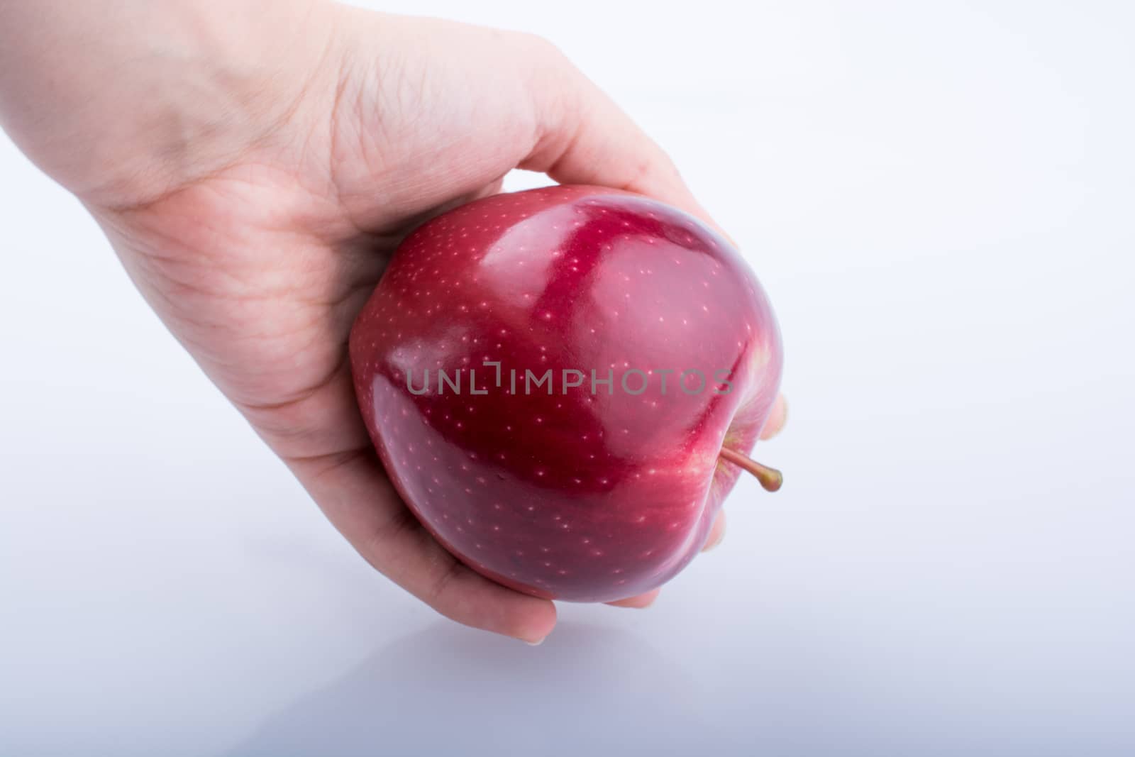 Little child hand holding an apple by berkay