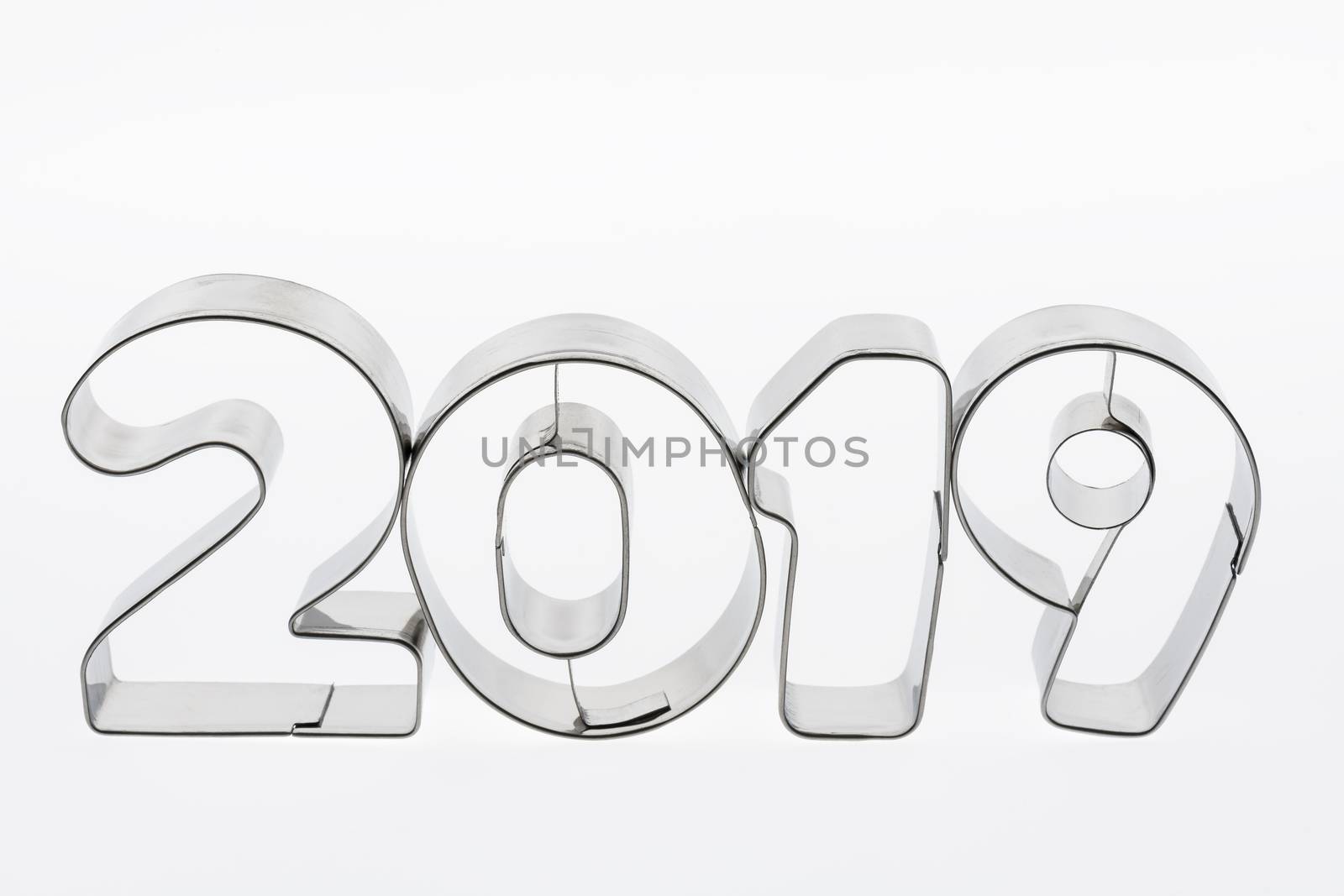 Text two thousand nineteen in metal put figures on a white background as a visualization of the coming new year
