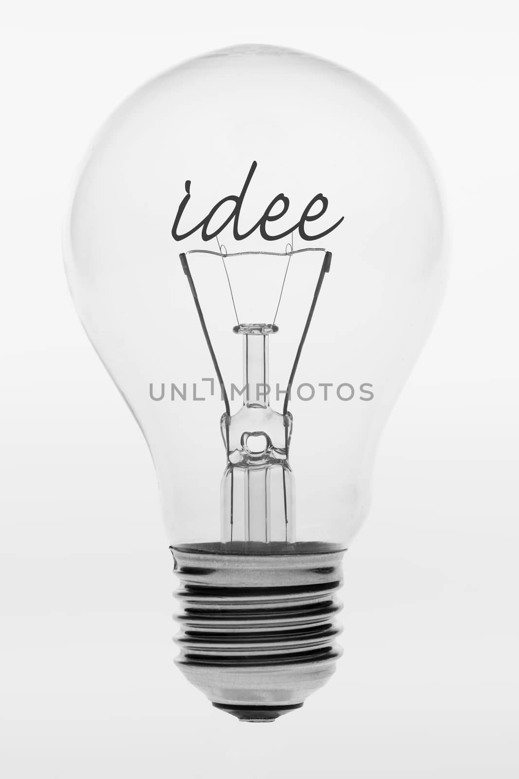Old fashioned light bulb with the Dutch text idea formed by filaments in the crystal ball
