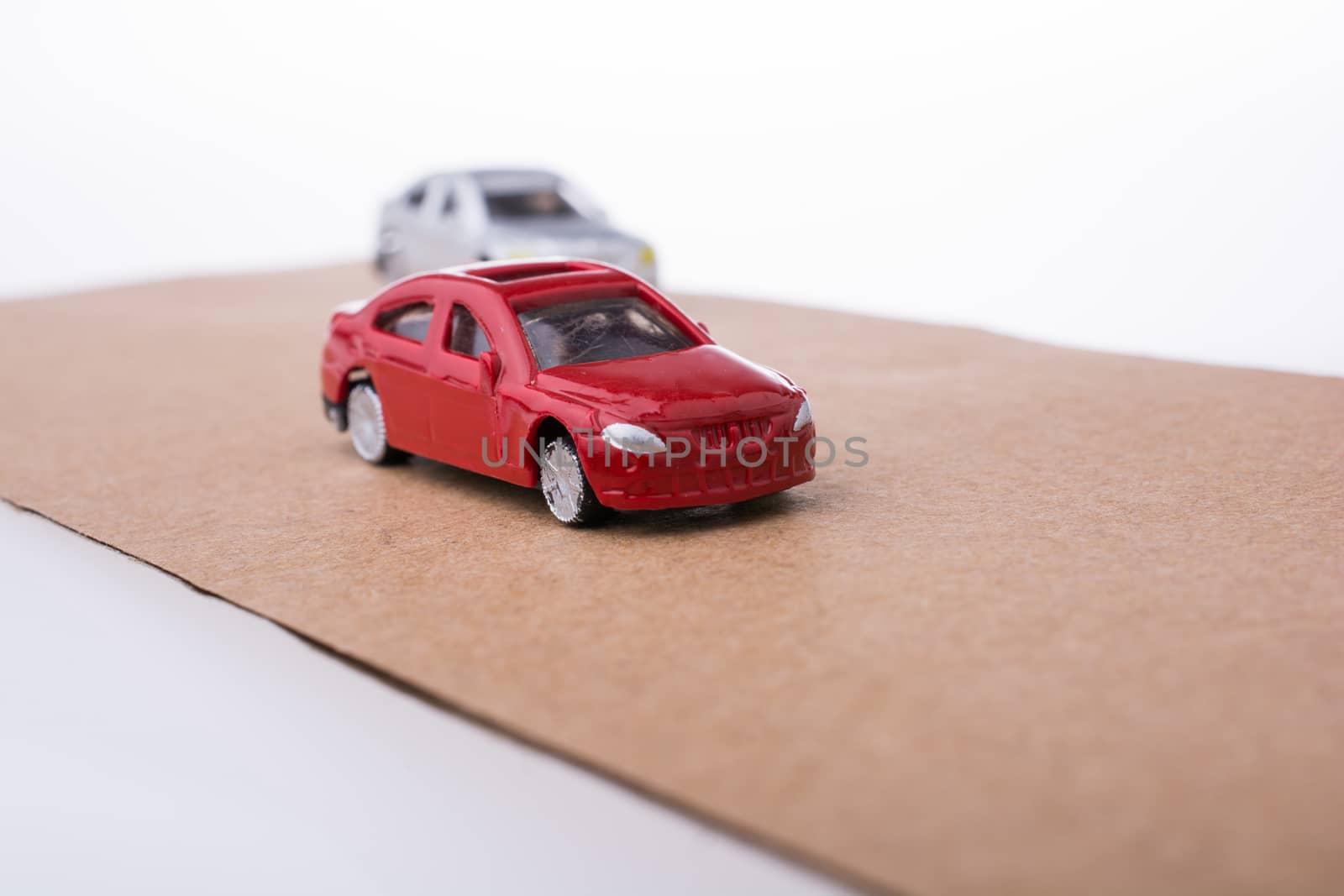Colorful little toy cars on white background
