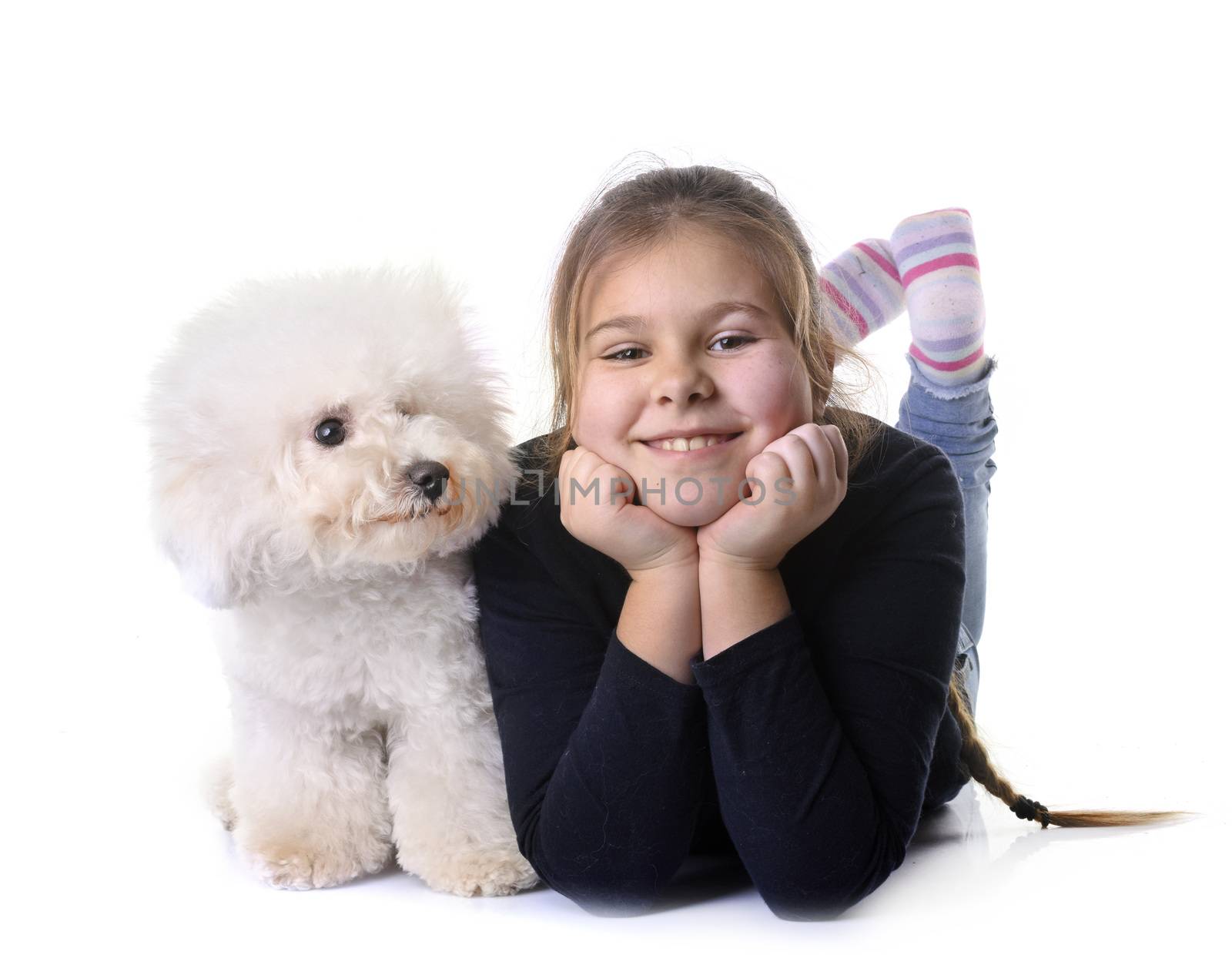 young girl and dog in front of white background