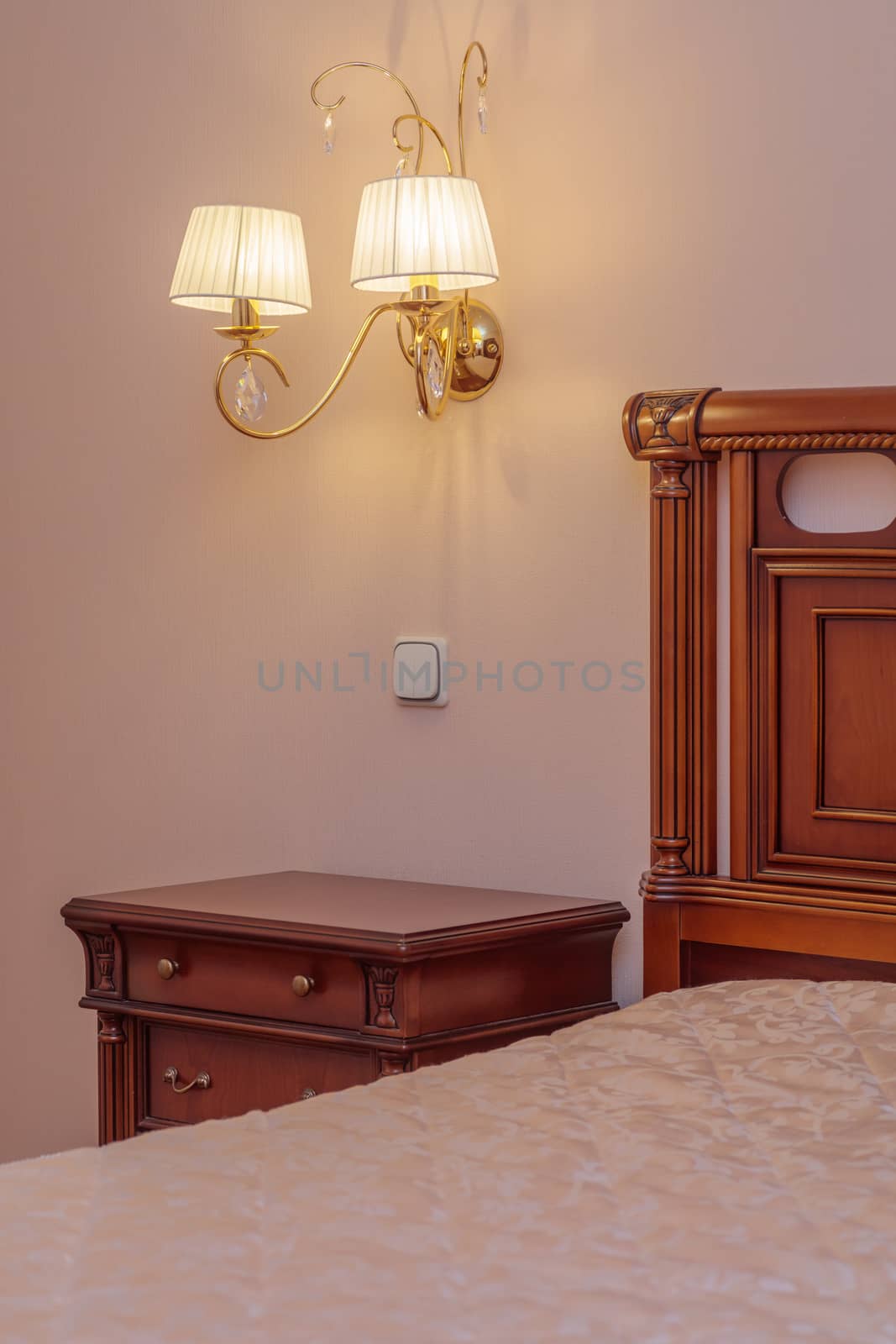 Warm cozy lamp near bed on nightstand