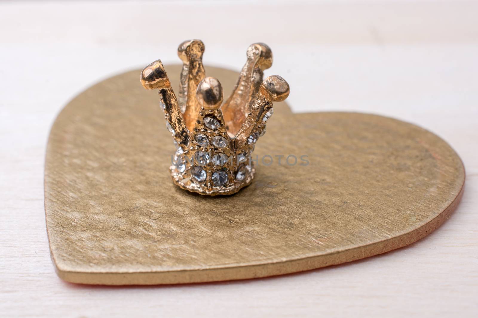 Little model crown placed on a  heart shape