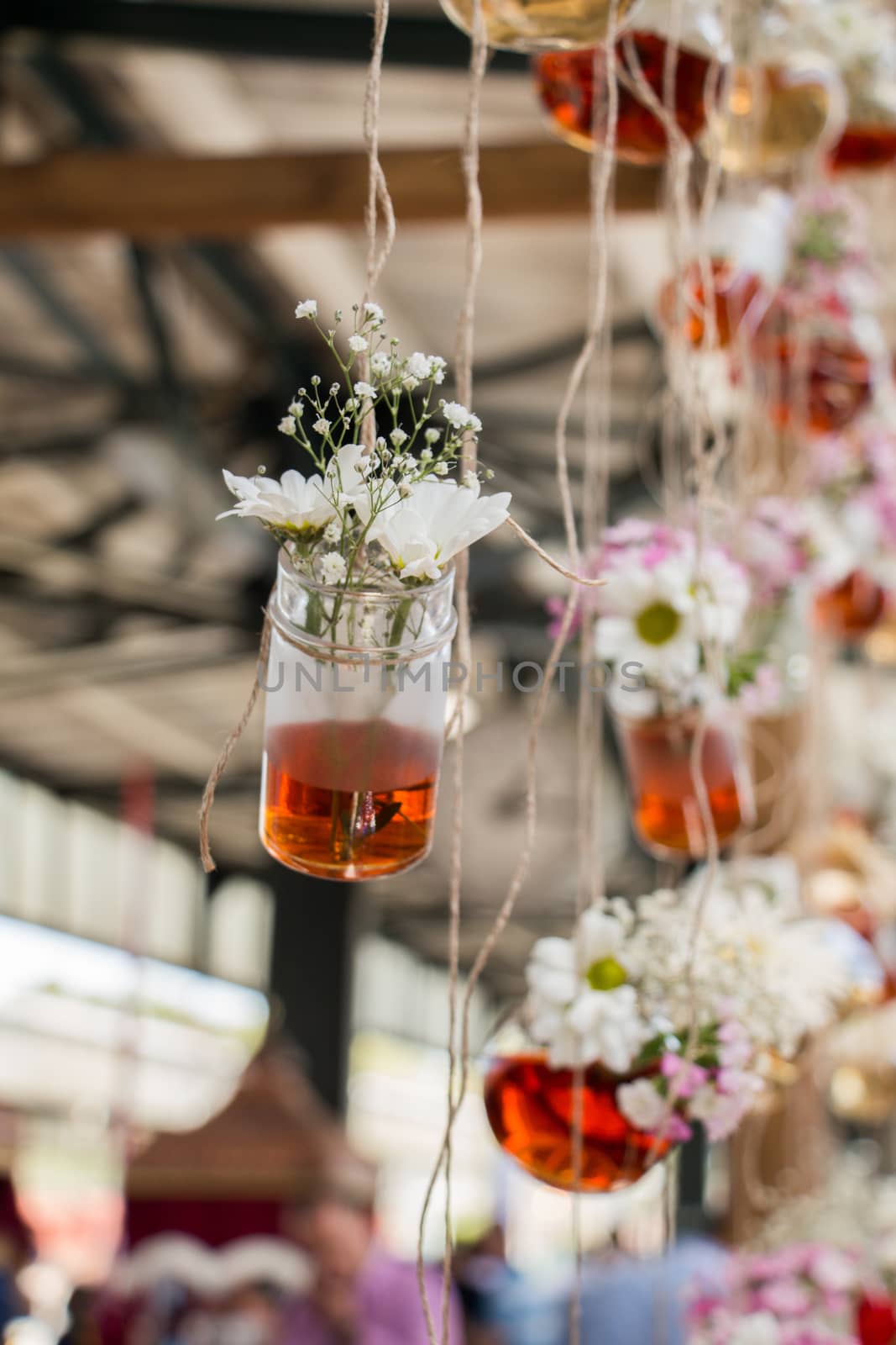 Herbal tea bottles with flowers hanging on strings