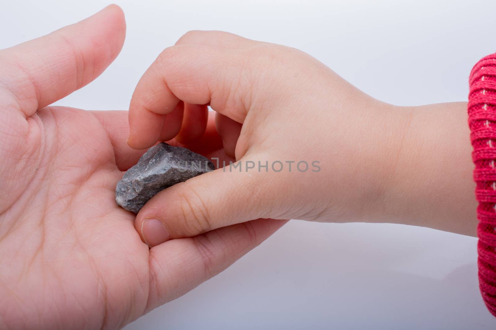 Hand holding a little stone in hand