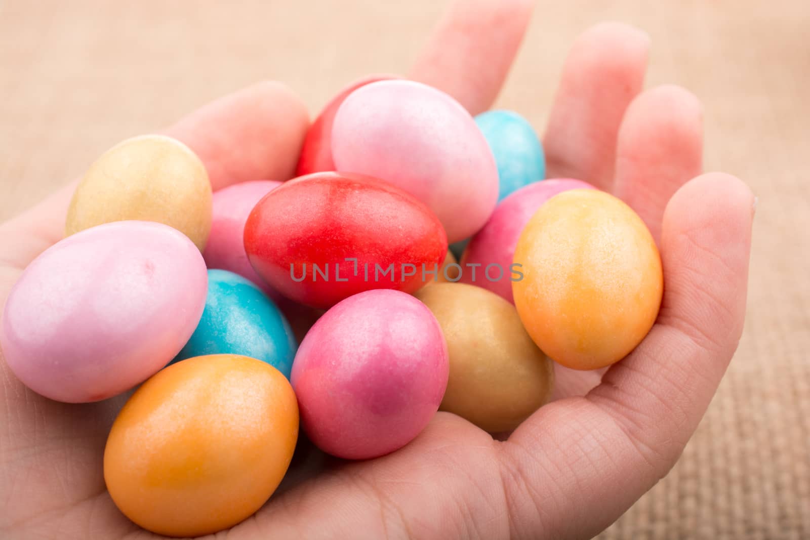 Candies in the concept  of Easter eggs in hand