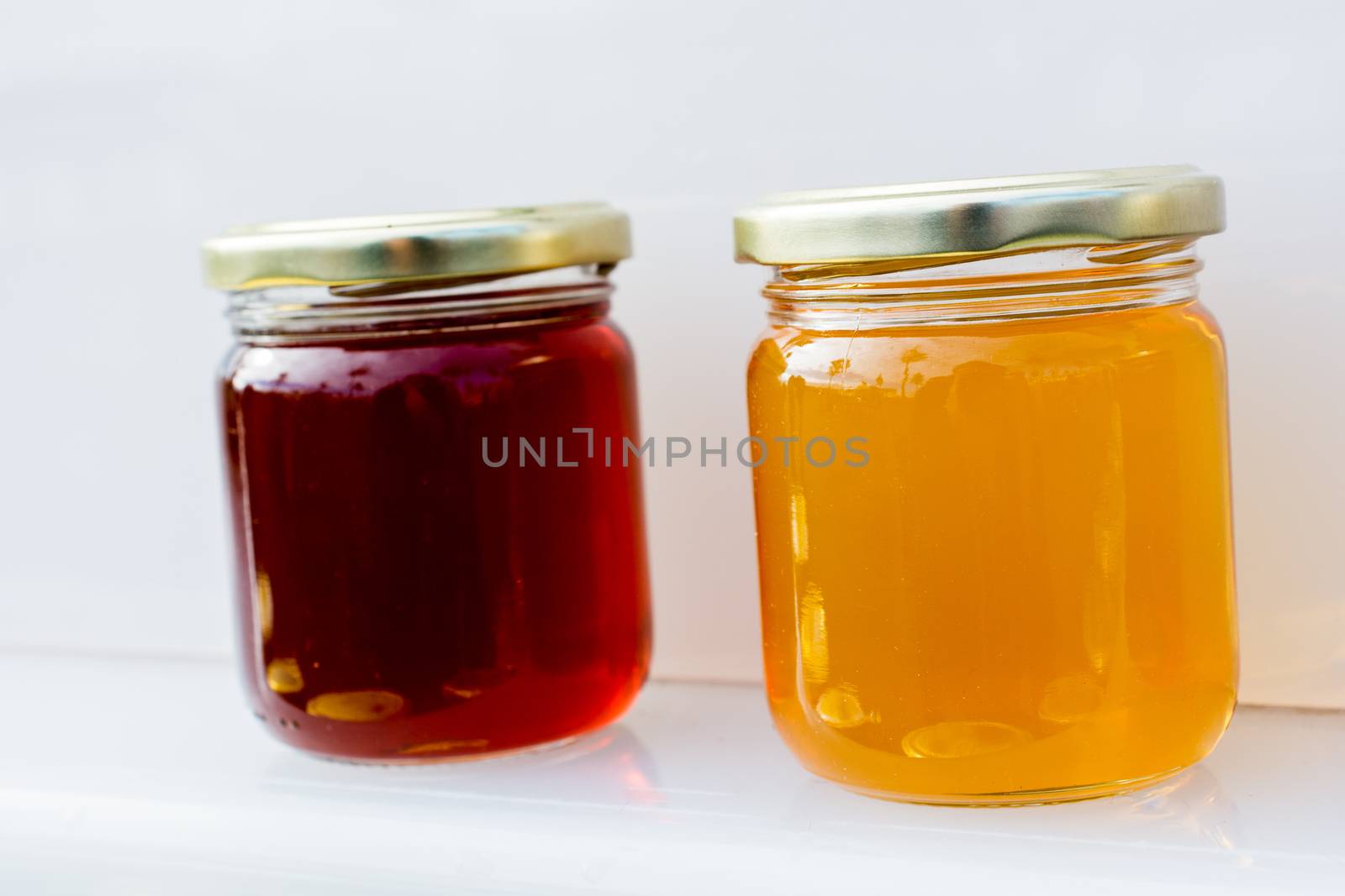 Glass jar of full of fresh honey with lid