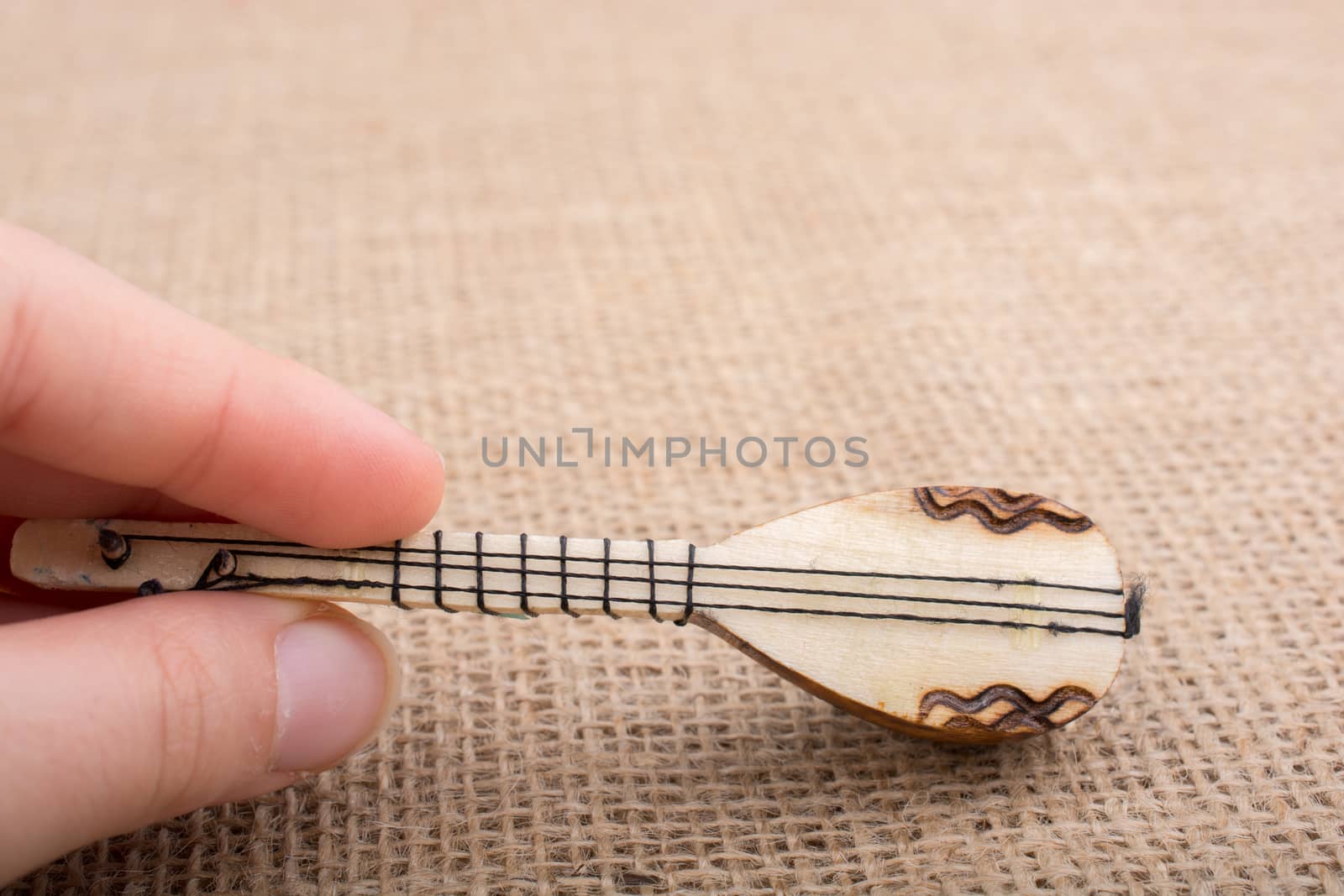 Model of Turkish musical instrument saz on a linen canvas