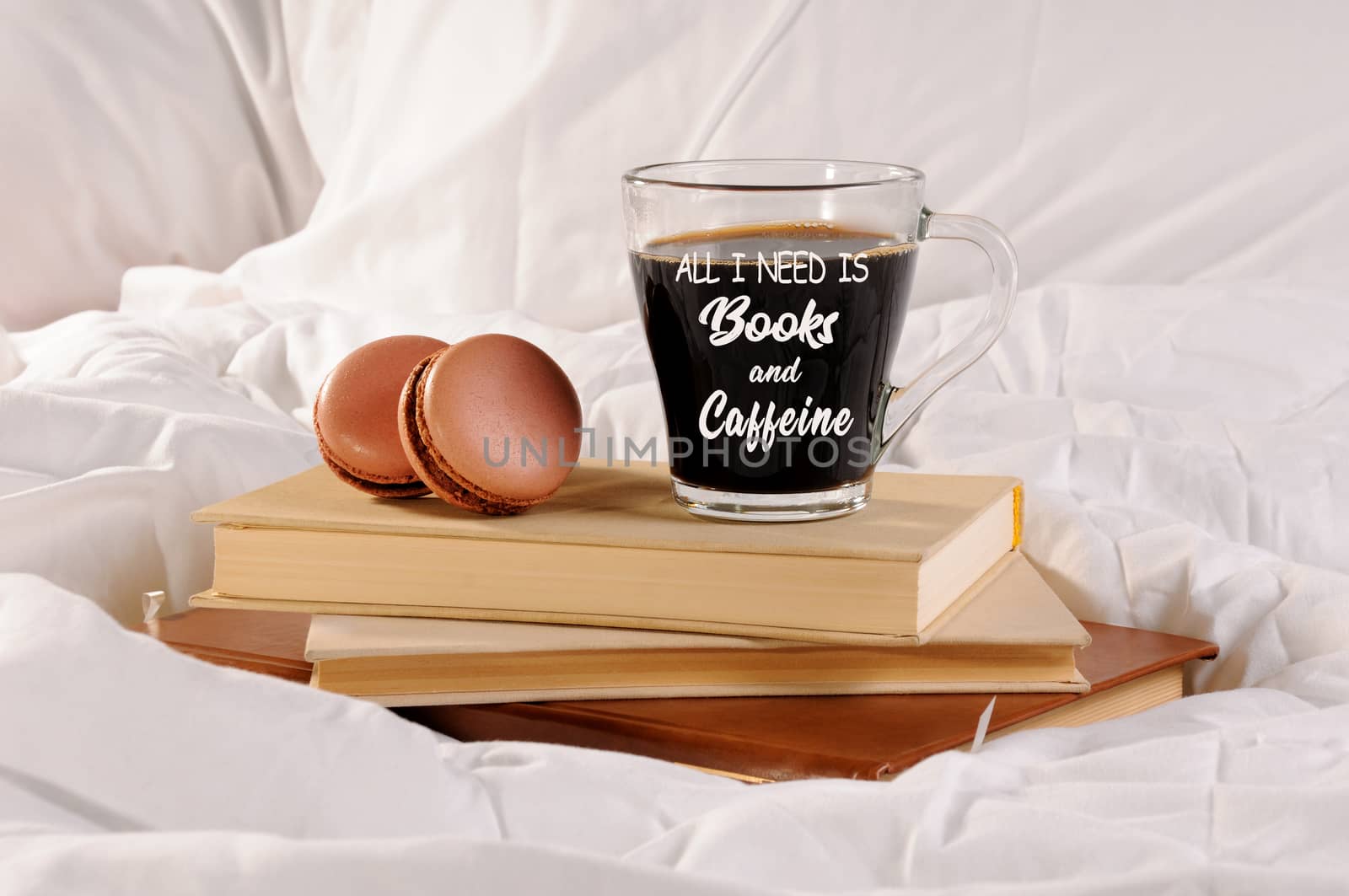 Morning cup of coffee with chocolate cakes Macaroons, on a pile of books in bed.
All I need is books and caffeine. 
