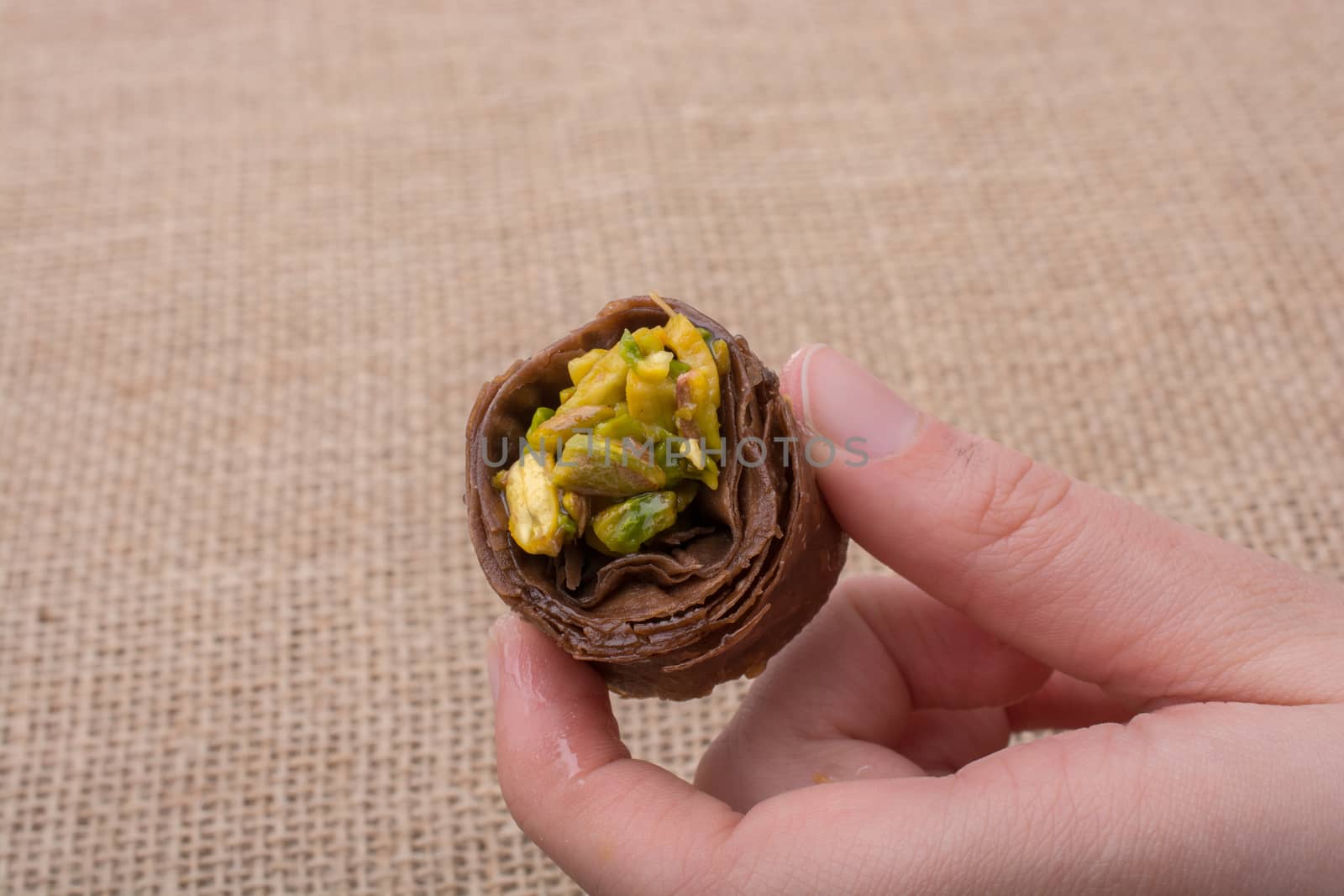 Nut stuffed dessert of mini size cuisine in hand