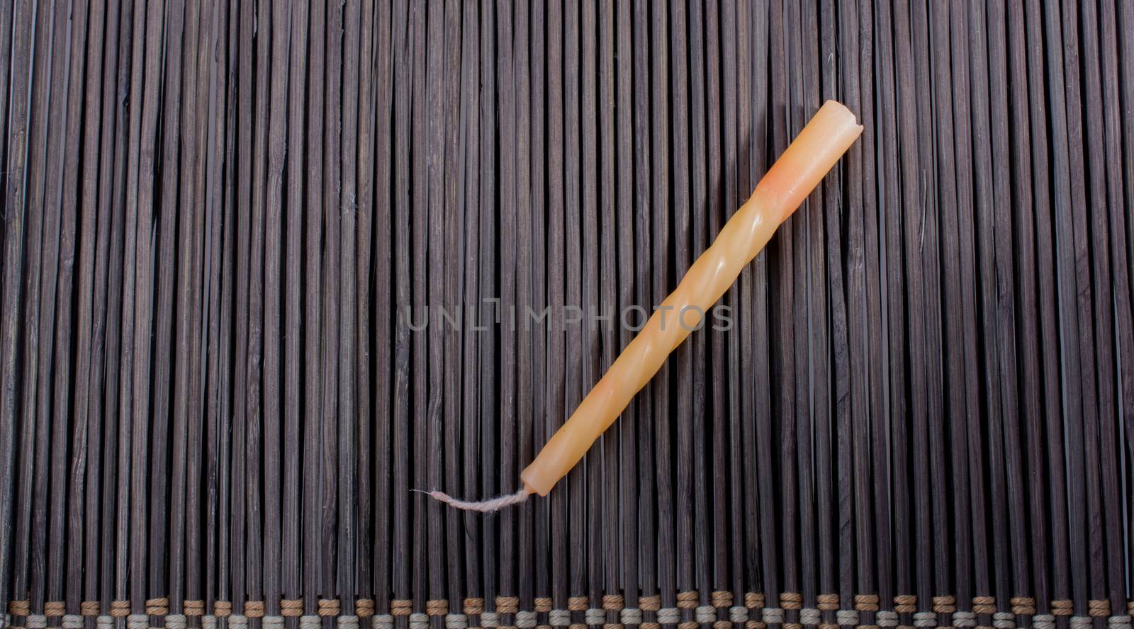 Colorful birthday candle  placed on a straw mat