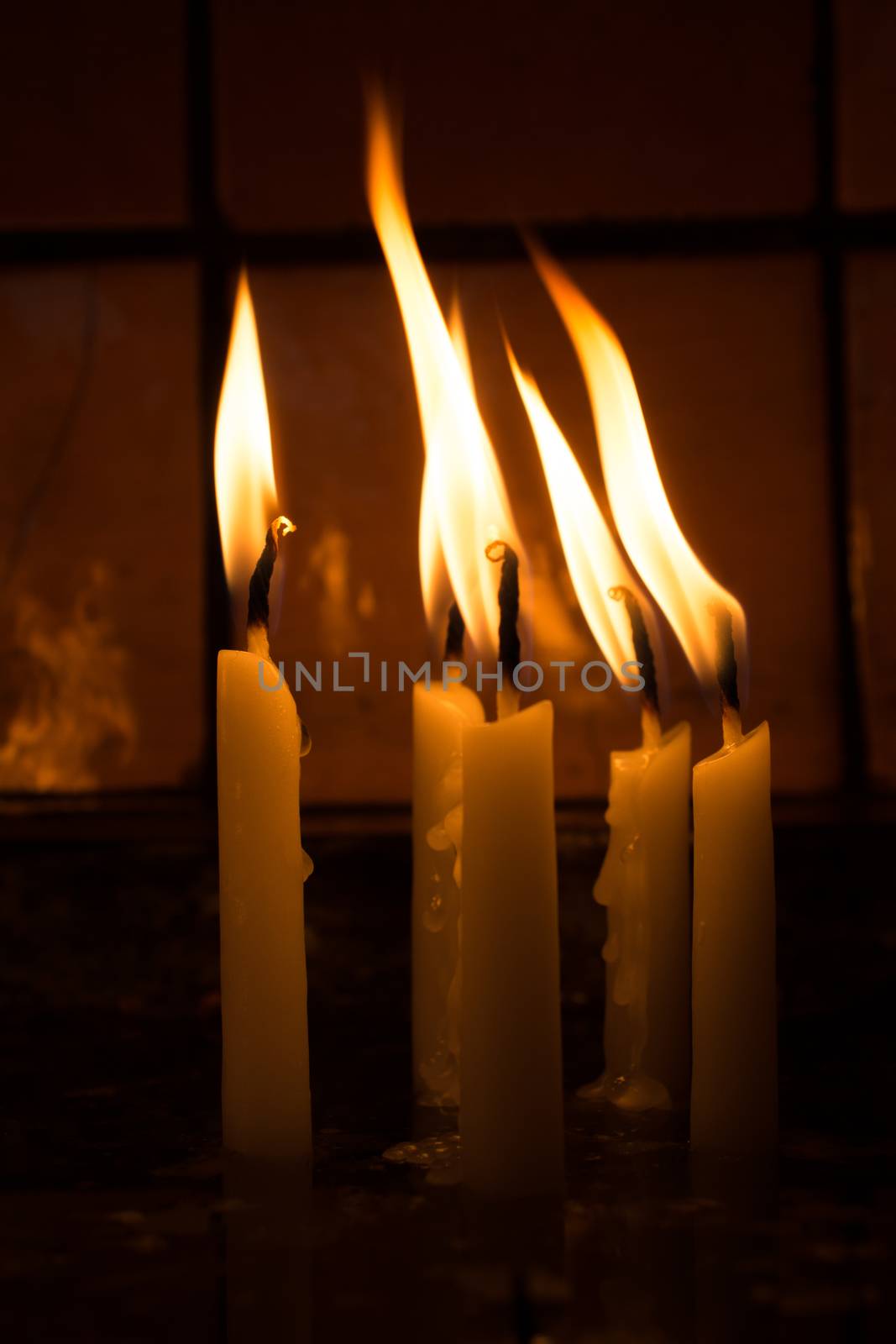 Burning candles with candle light in the dark