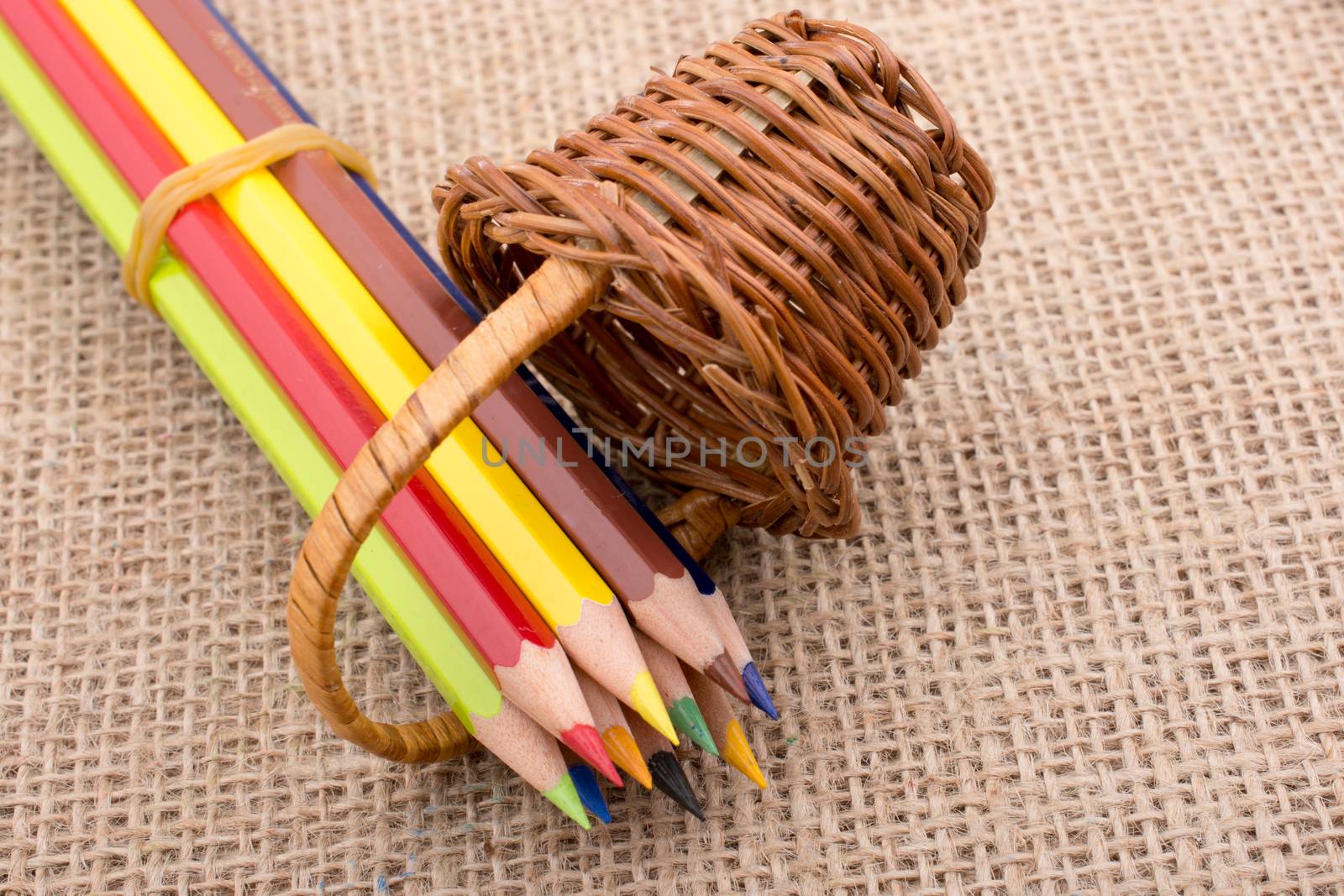 Color Pencils and a mini basket on canvas