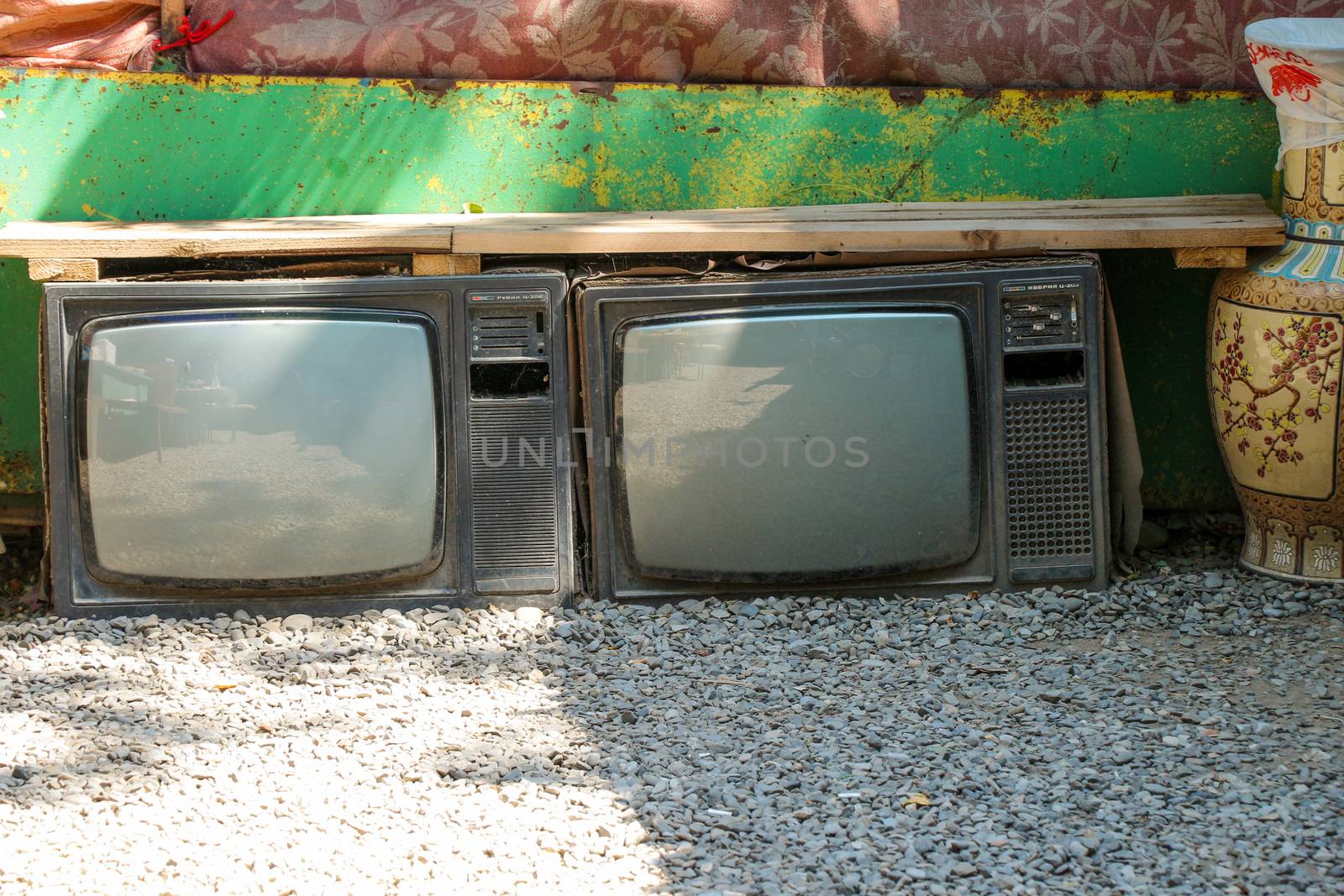 A Broken Television Abandoned on the ground outside in the street