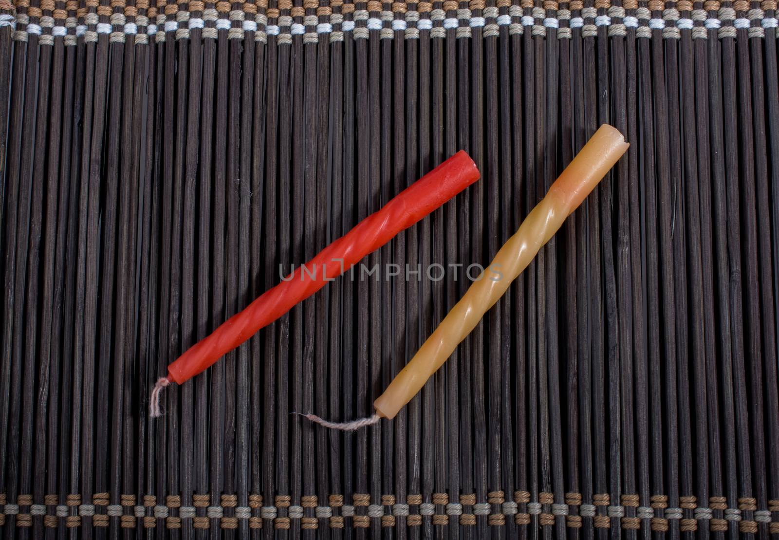 Colorful birthday candle  placed on a straw mat