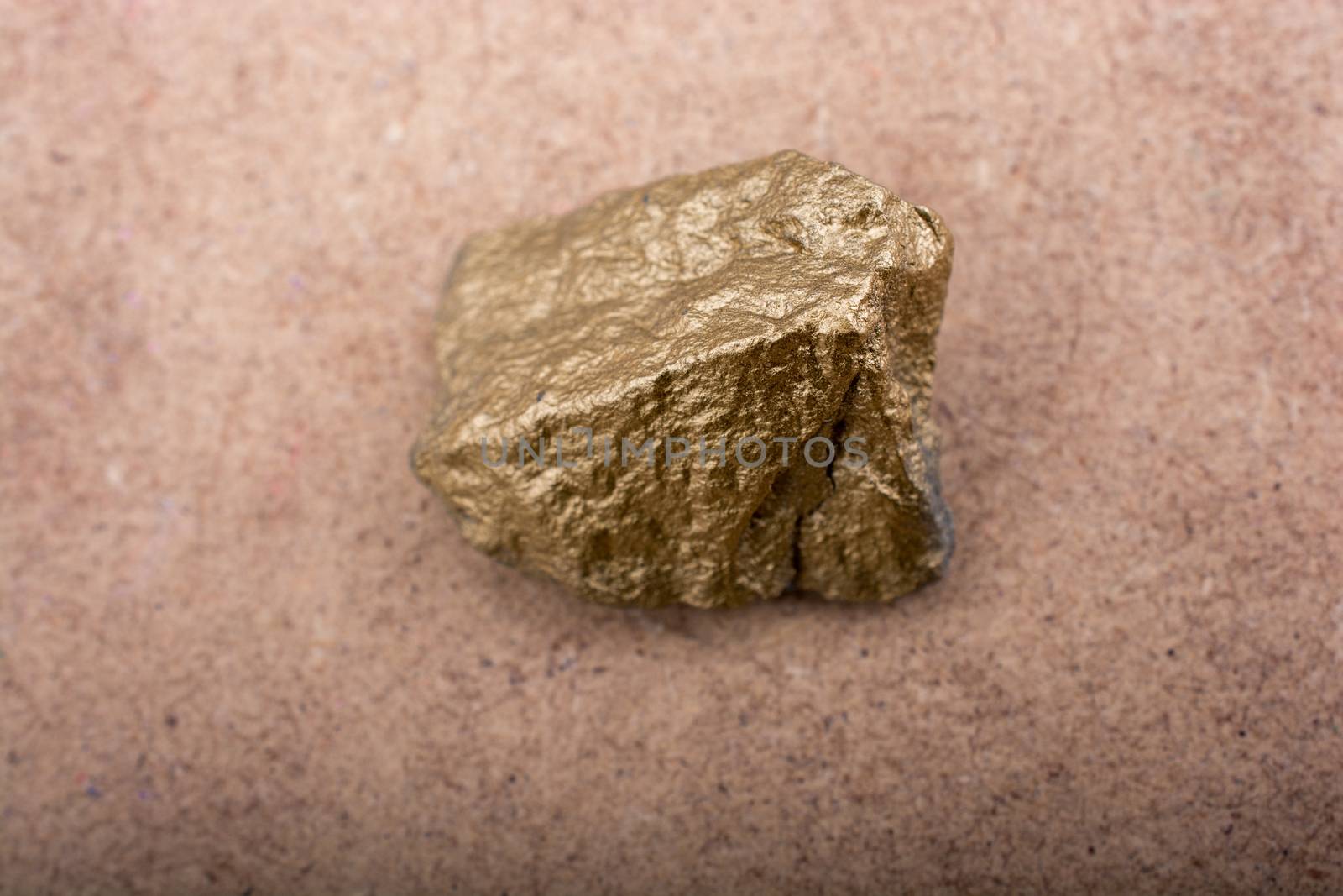 little gold color stone on brown background