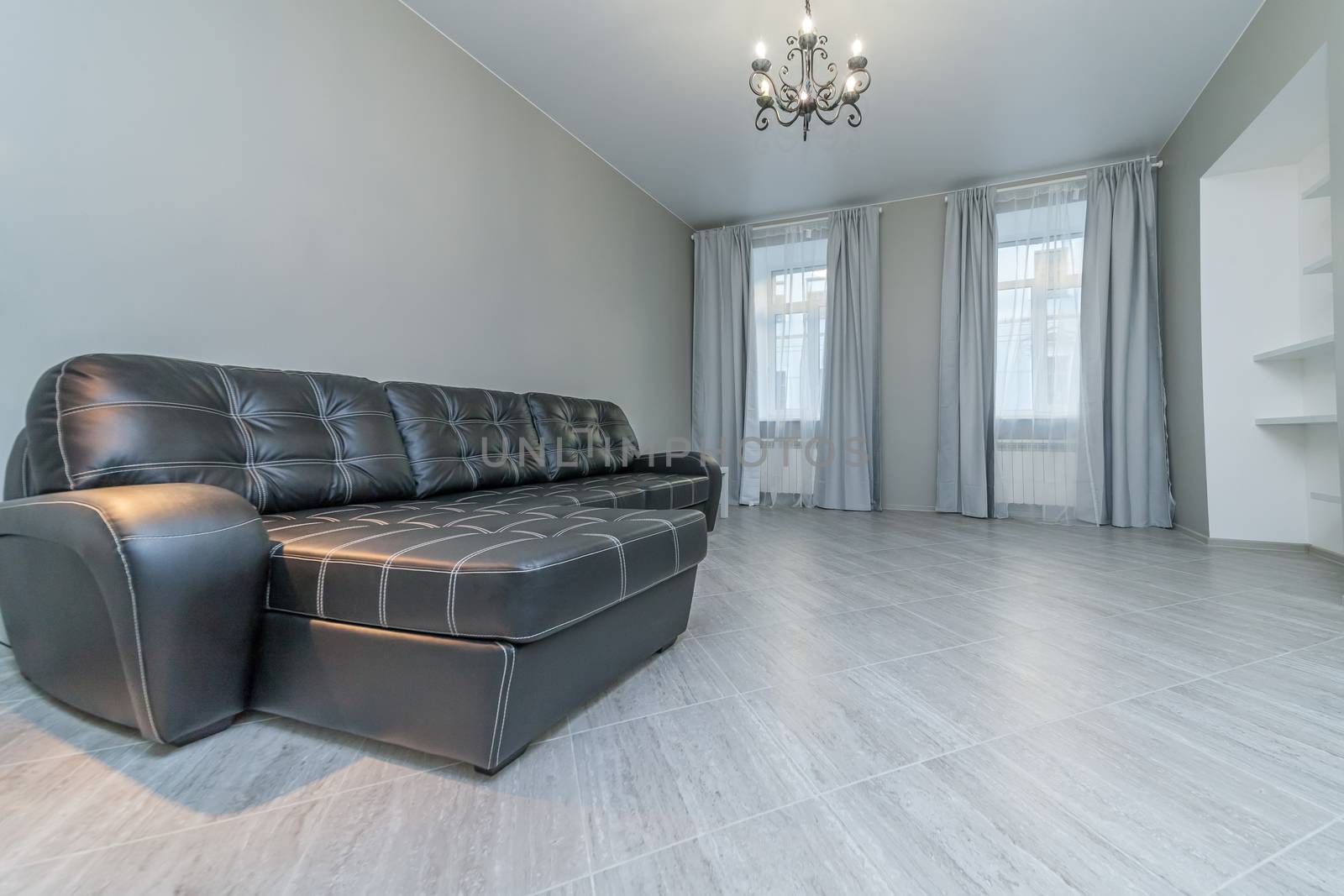 Cozy comfortable new sofa standing in empty modern room