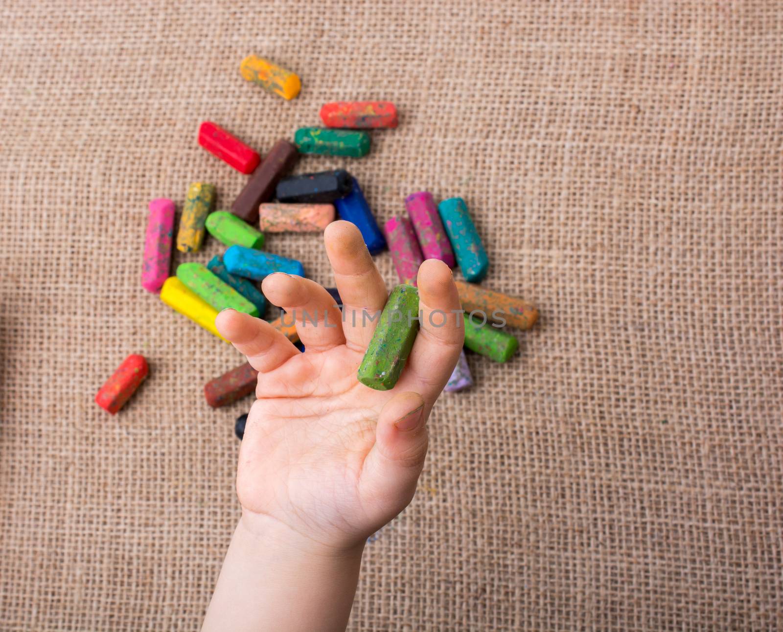 Used  color crayons and a toddlers hand holding one