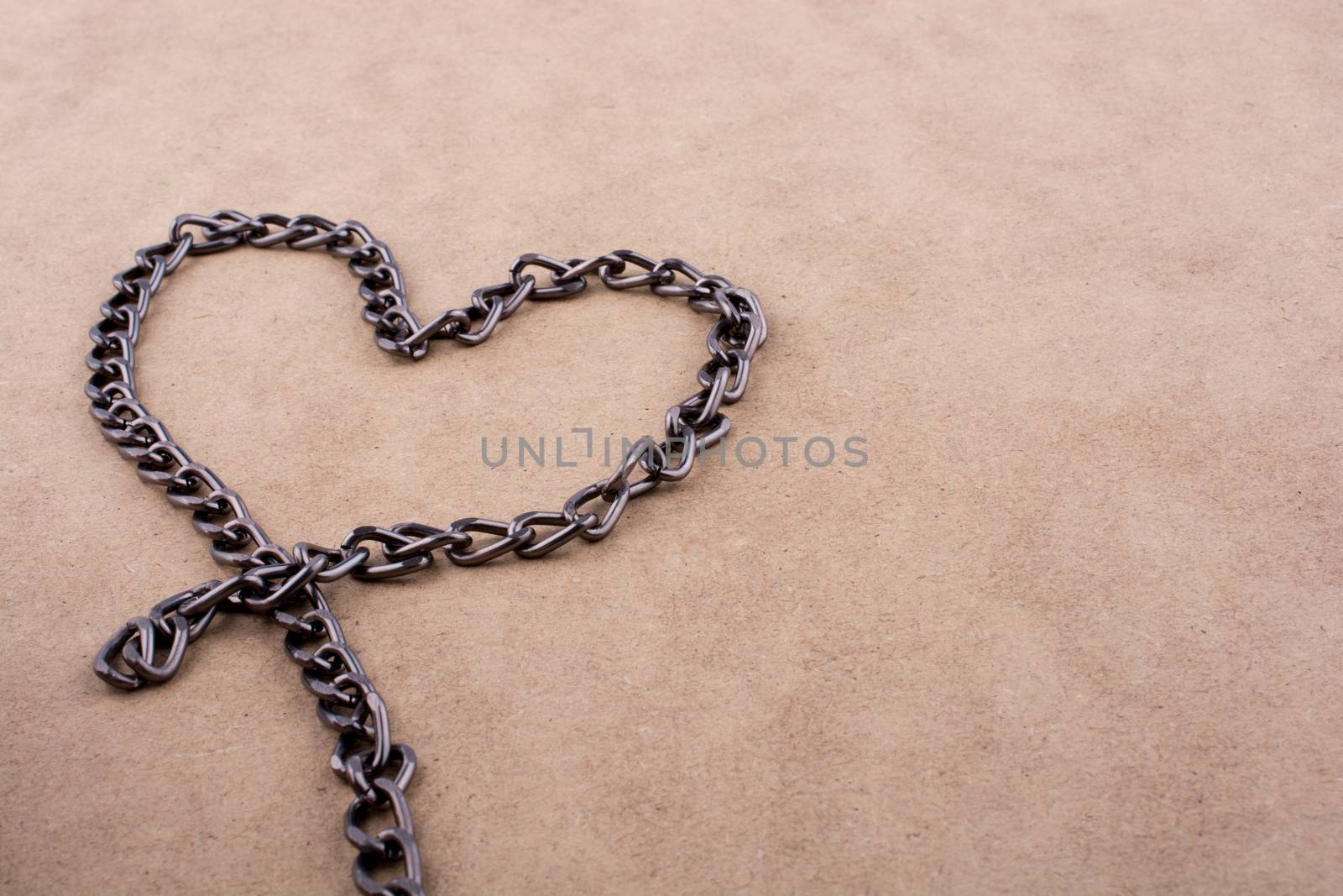 Chain form a heart shape on a brown background