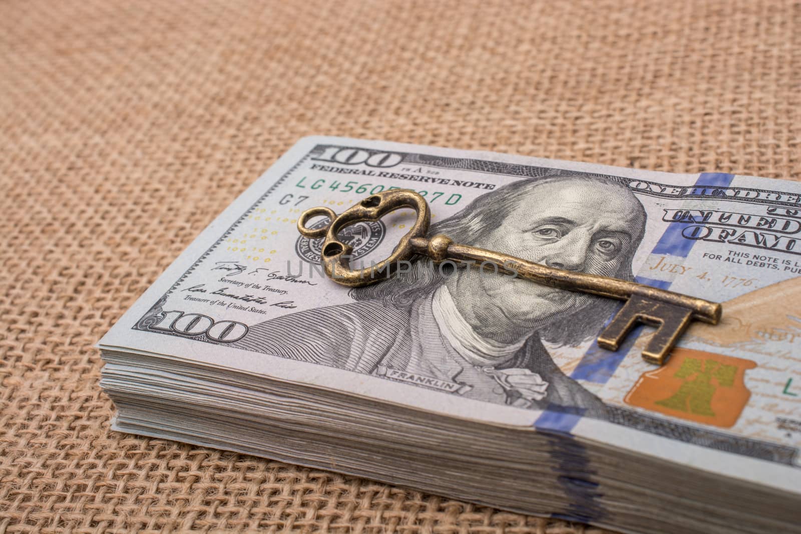 Retro styled key placed of a bundle of US dollar