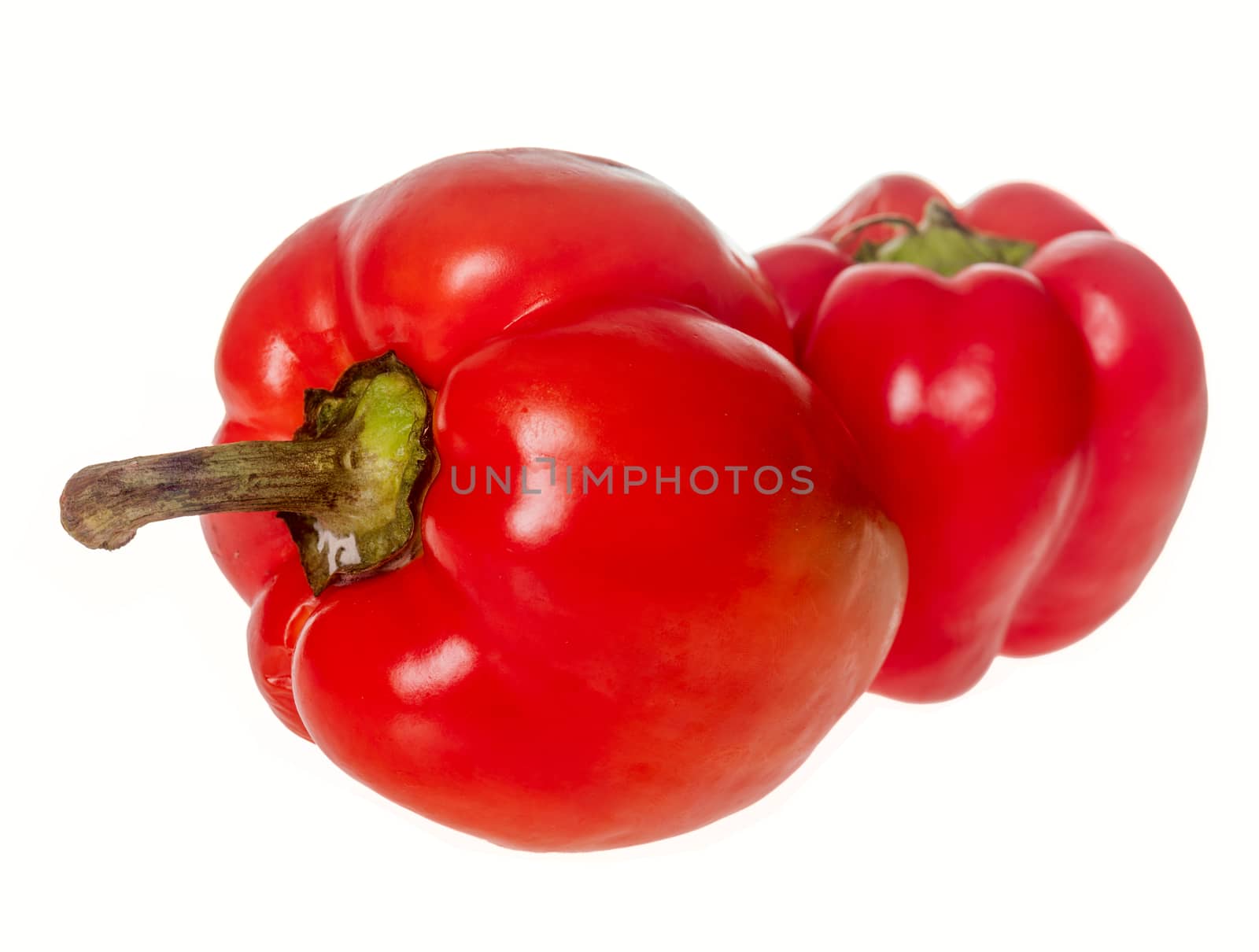 Two ripe sweet jusy red peppers isolated on white