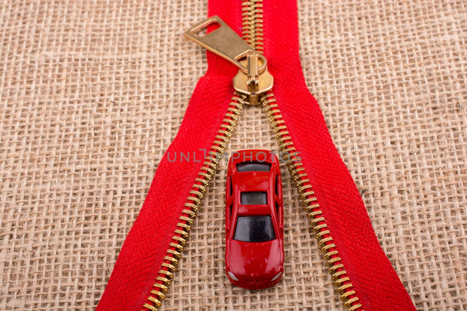 Toy car as a transportation devices in hand on a canvas background