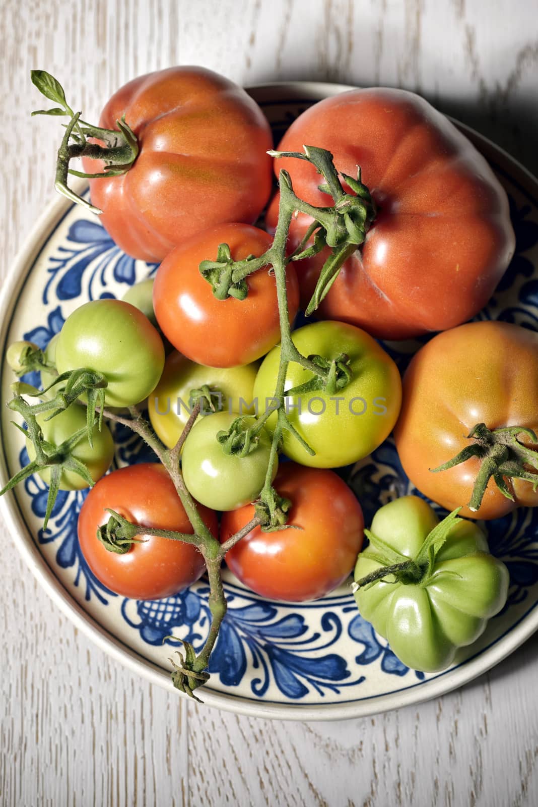 Fresh tomatoes on traditional plate