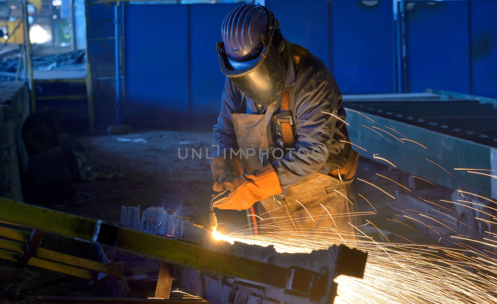 Welder work inside of construction plant