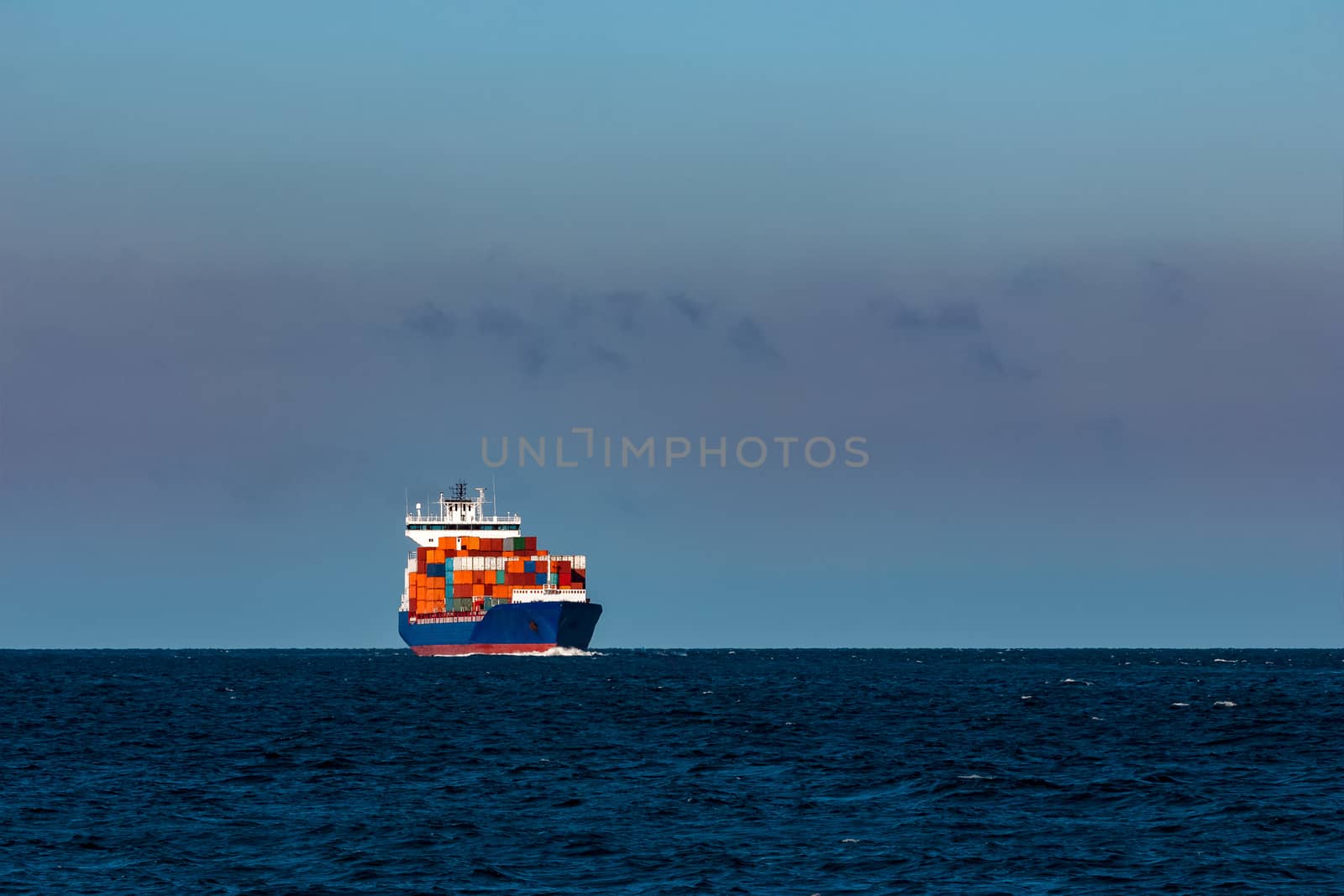 Blue container ship in Baltic sea by sengnsp