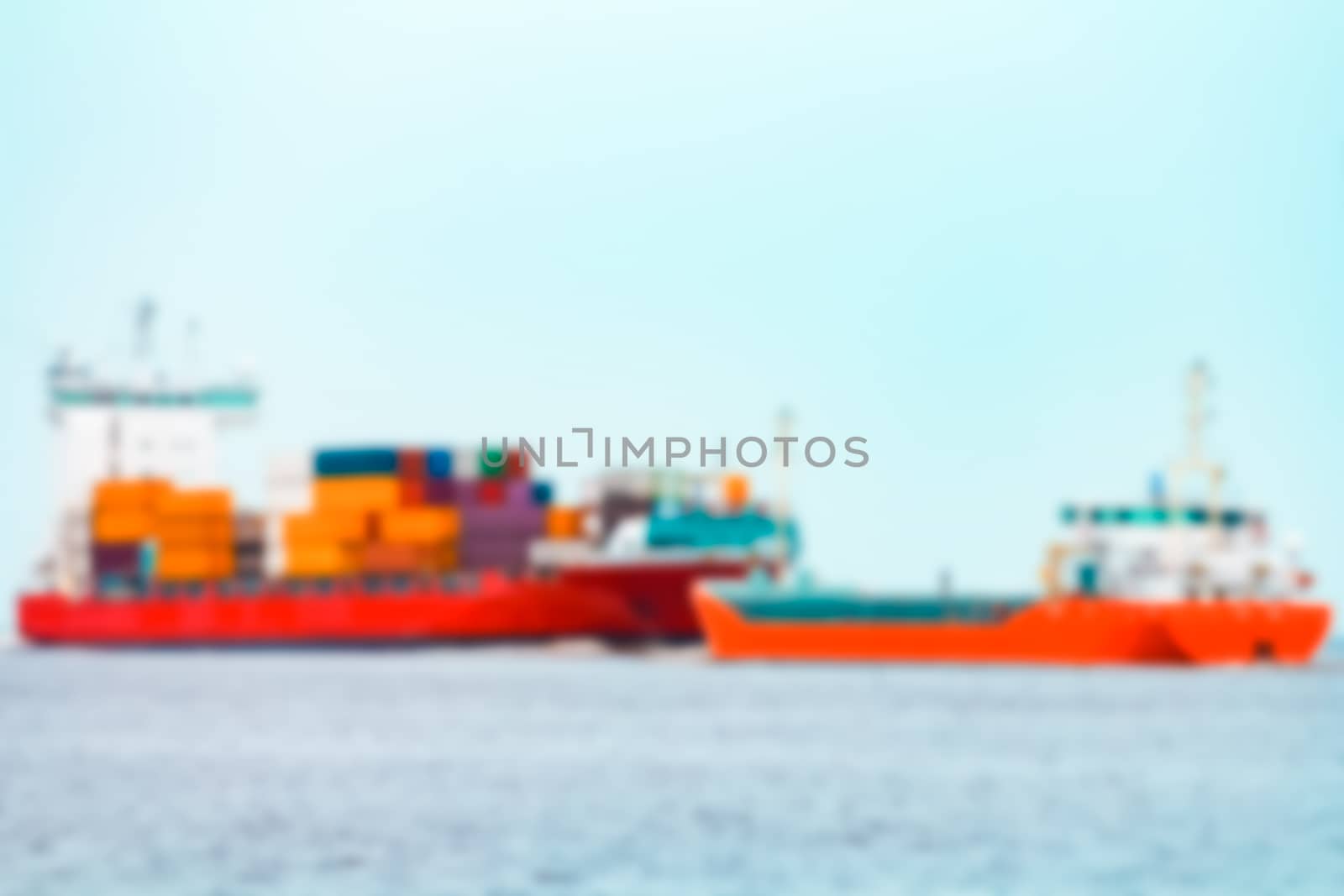 Red cargo ship - soft lens bokeh image. Defocused background