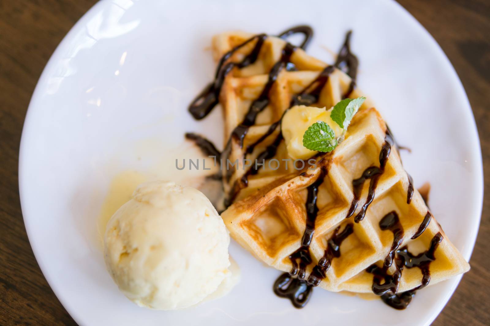 waffles with ice cream with chocolate and mint leaf, top view