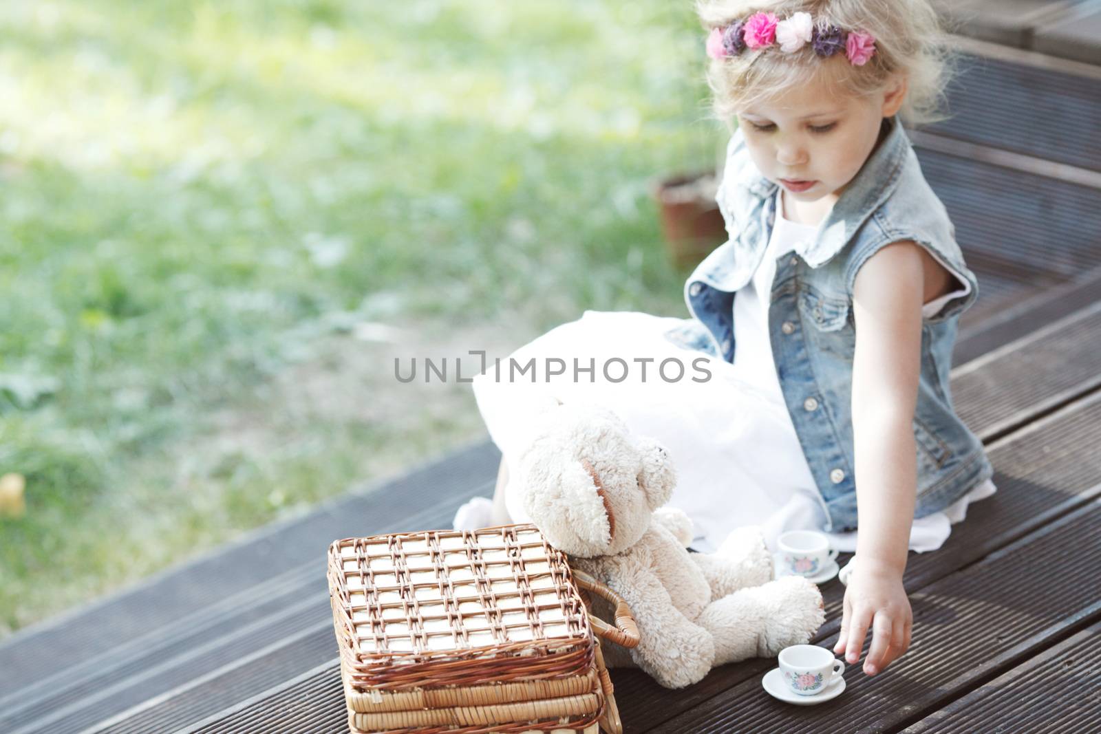 Girl playing with teddy bear by ALotOfPeople