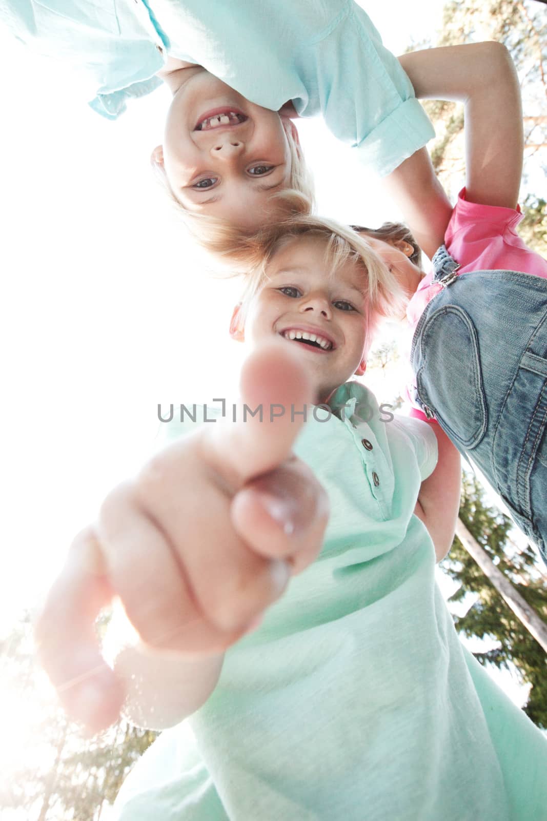 Group of smiling children looking down into camera